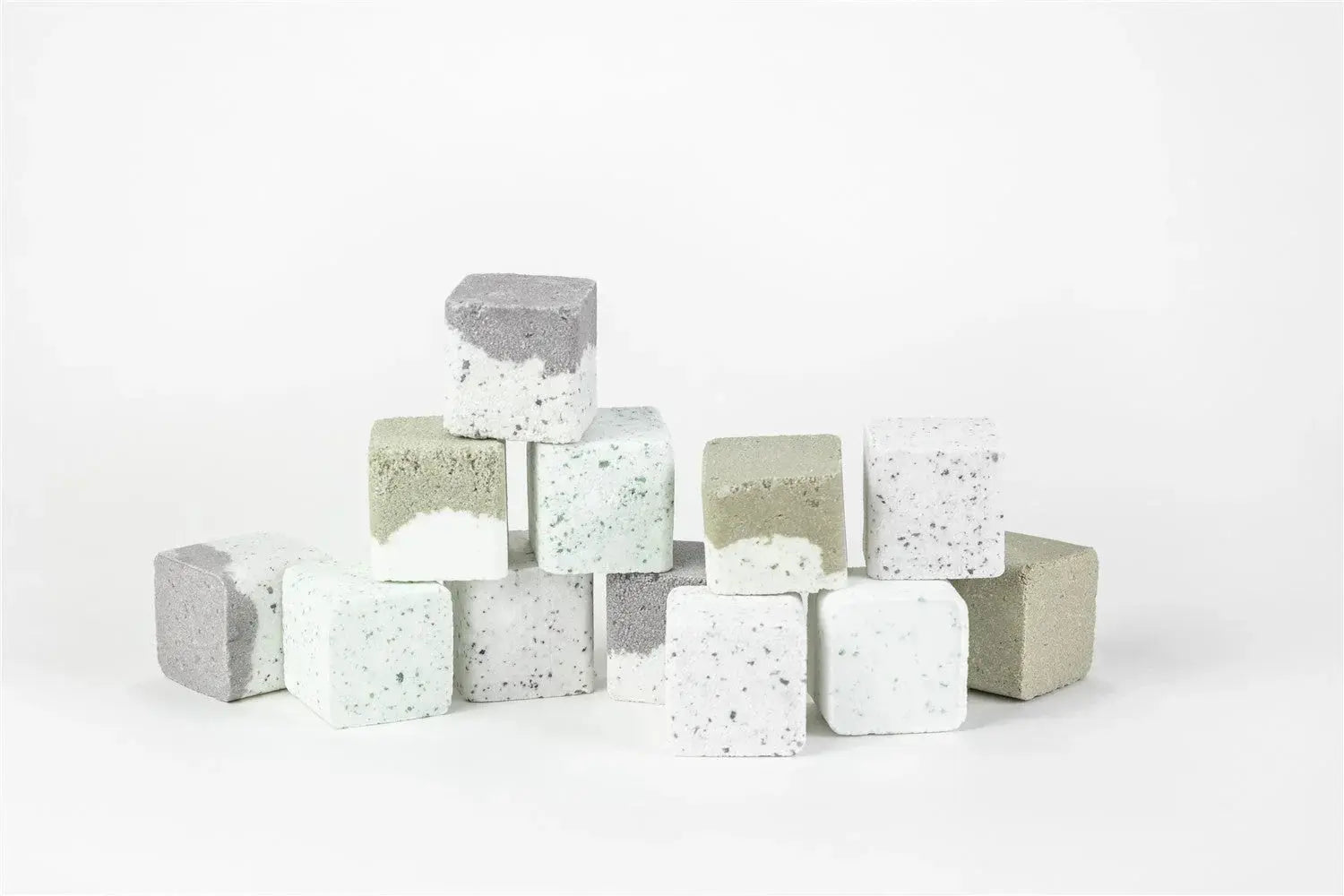 Cozy farmhouse bath bombs in gray, white, and sage green cubes for relaxing self-care routines