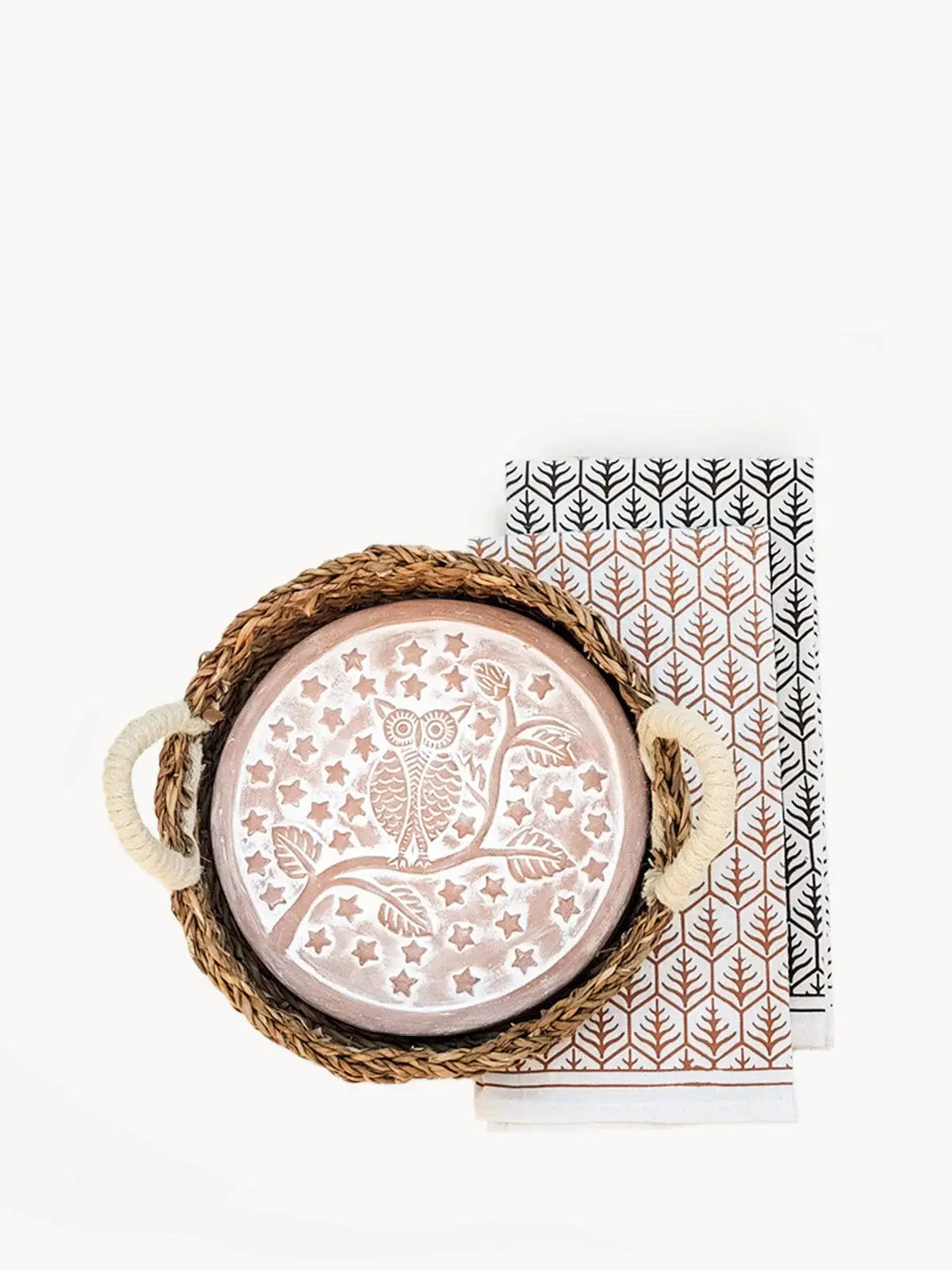 Owl decorative plate in woven tray with patterned tea towels, farmhouse home decor