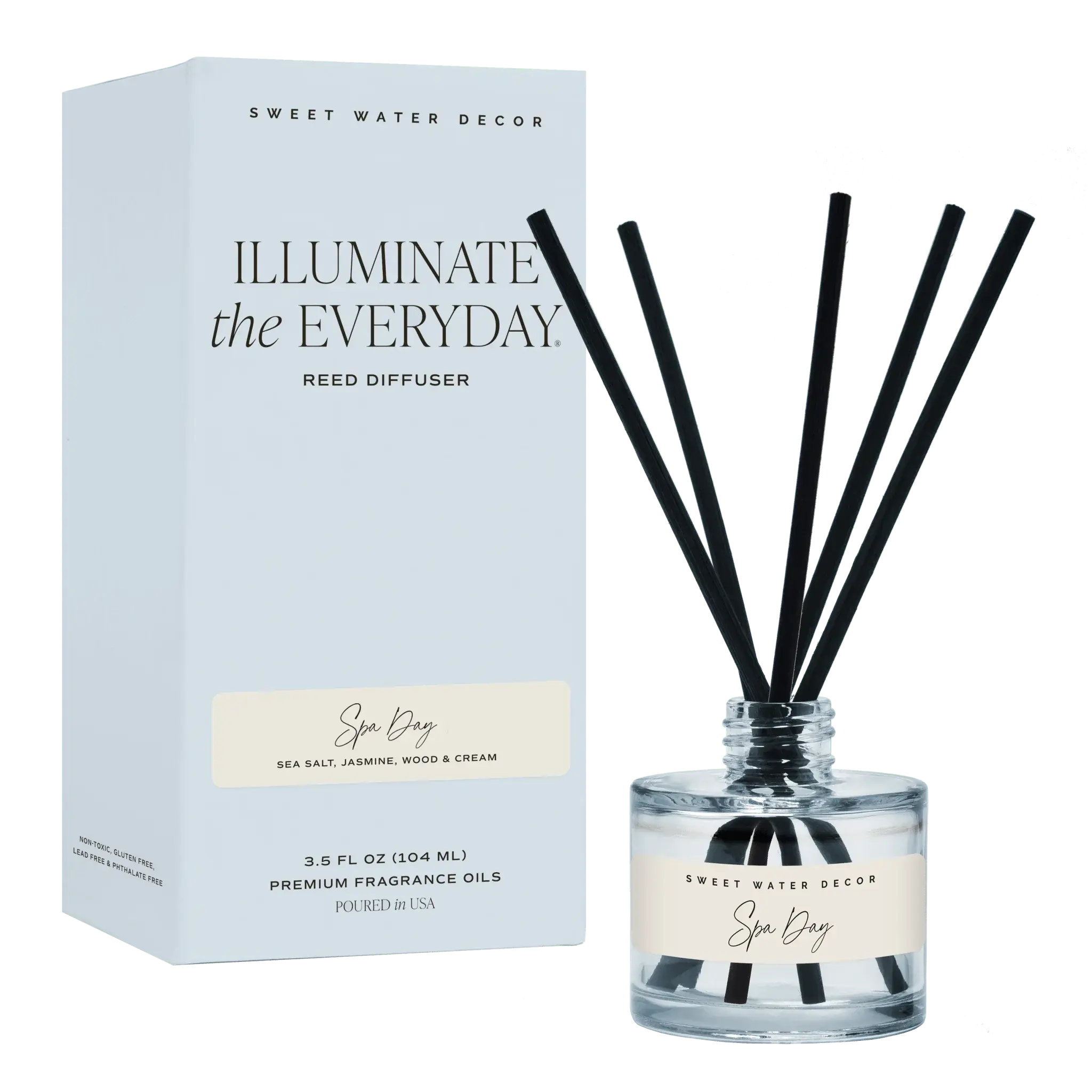 Spa Day reed diffuser with black sticks, clear glass bottle, and light blue packaging for cozy home fragrance.