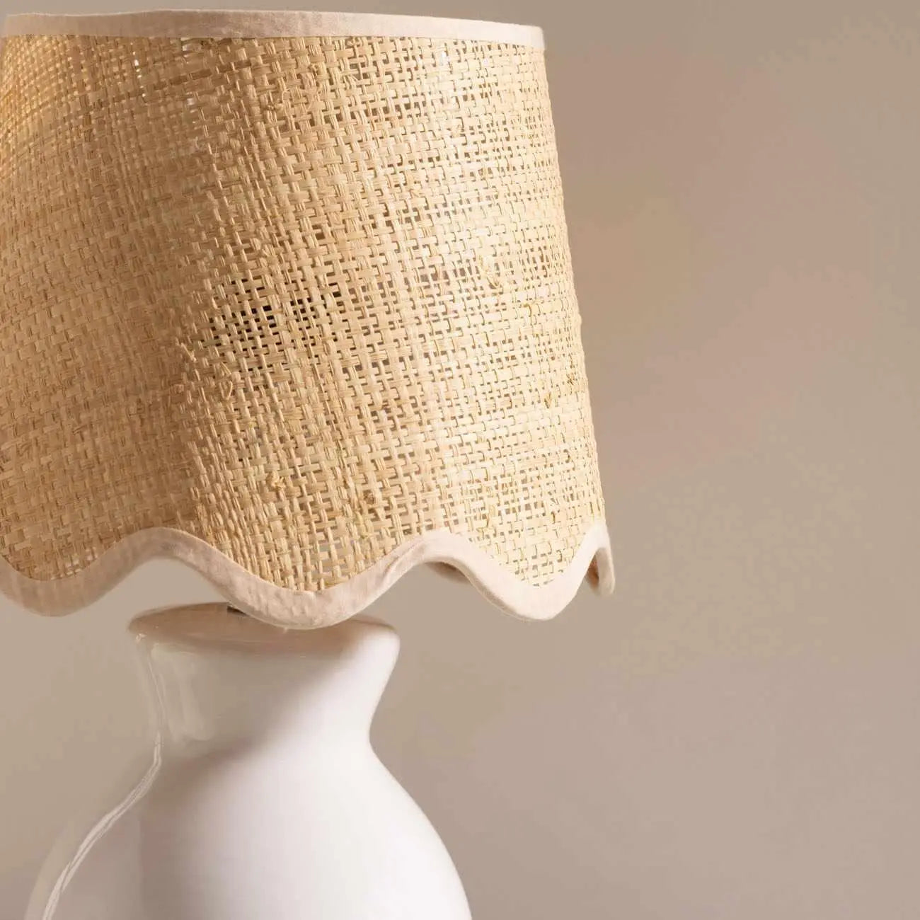 Woven rattan lampshade with scalloped edge on white ceramic base, farmhouse cottage decor