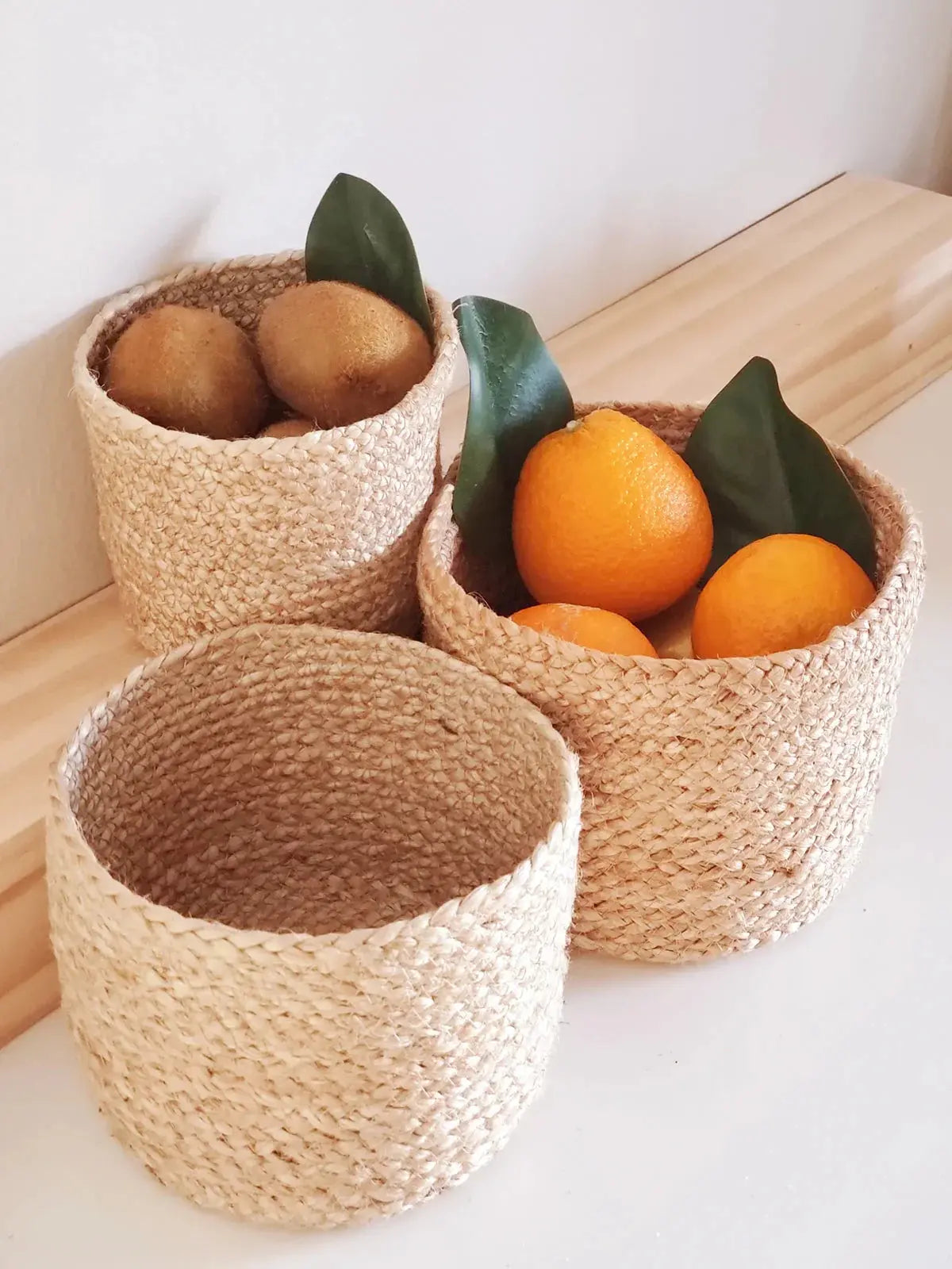 Woven seagrass baskets with kiwis and oranges, farmhouse kitchen decor