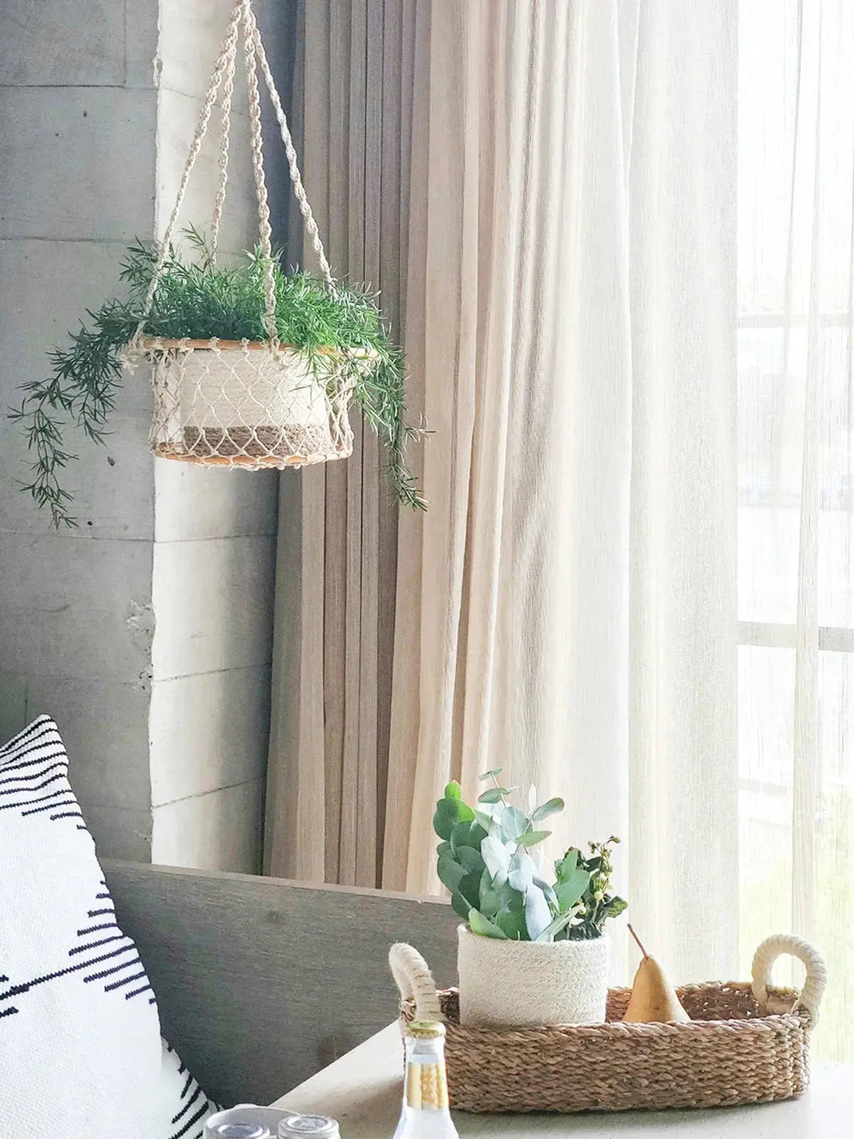Macrame hanging planter with greenery, farmhouse decor by window with woven basket and eucalyptus