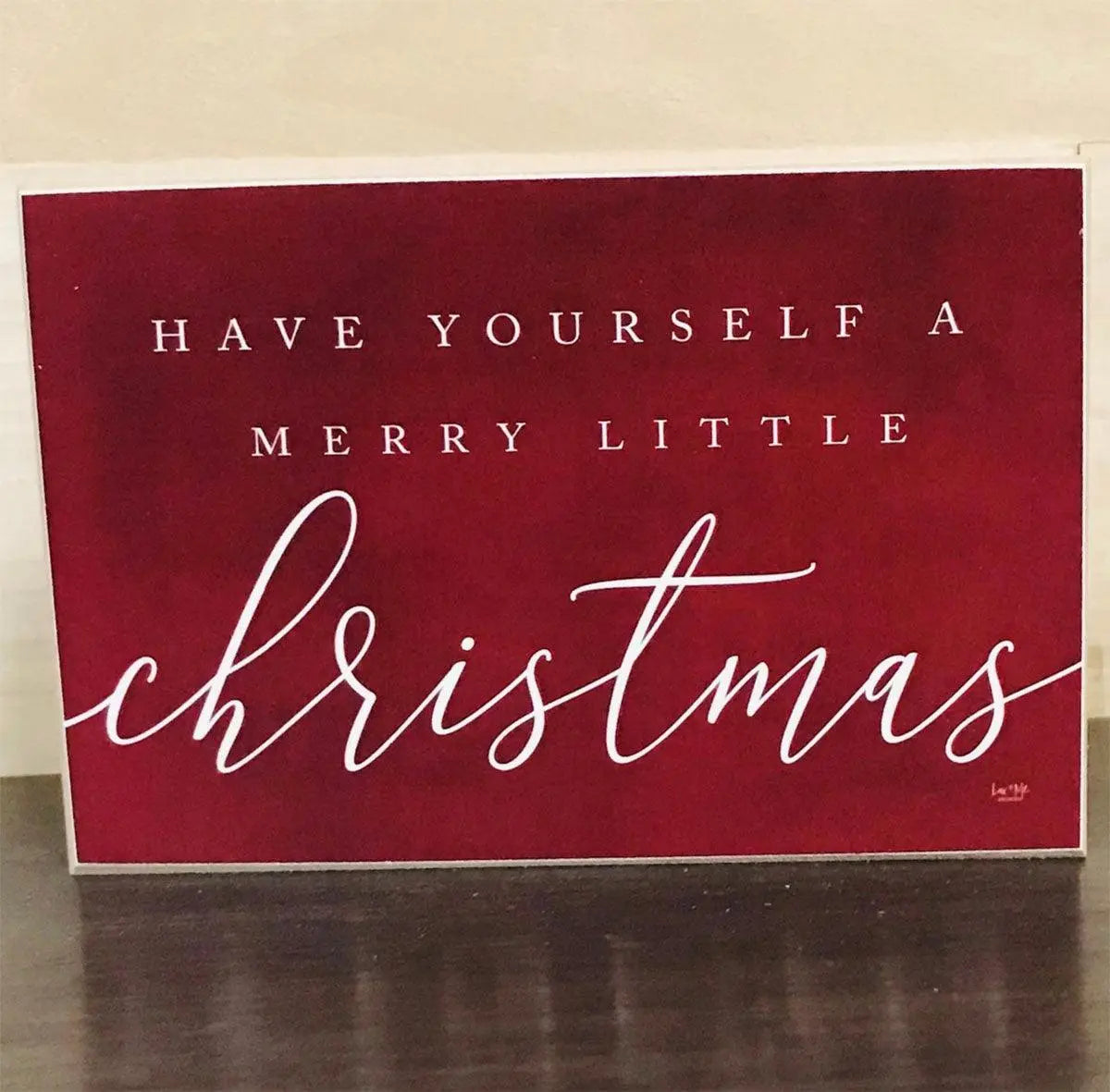 Red Christmas card with white text on a beige background