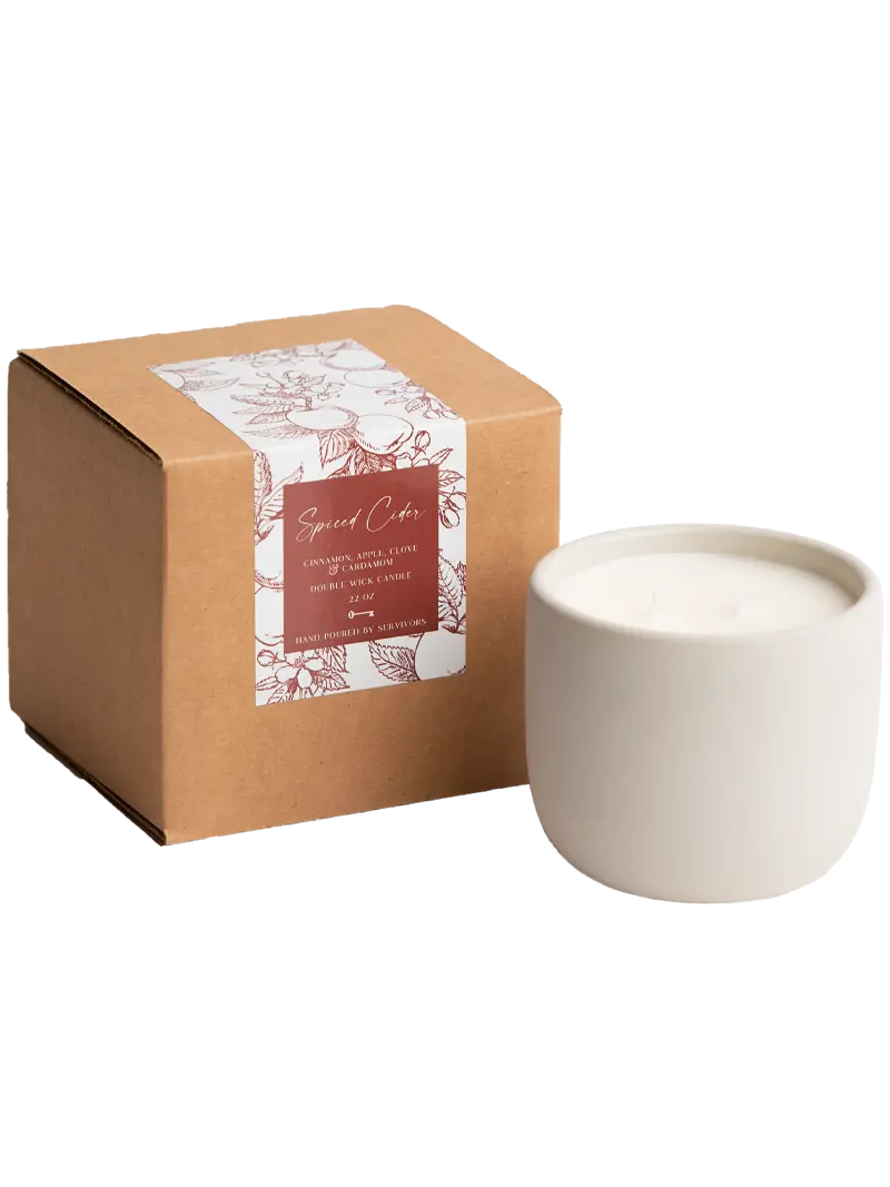 Ceramic candle in a cardboard box with a label on a white background