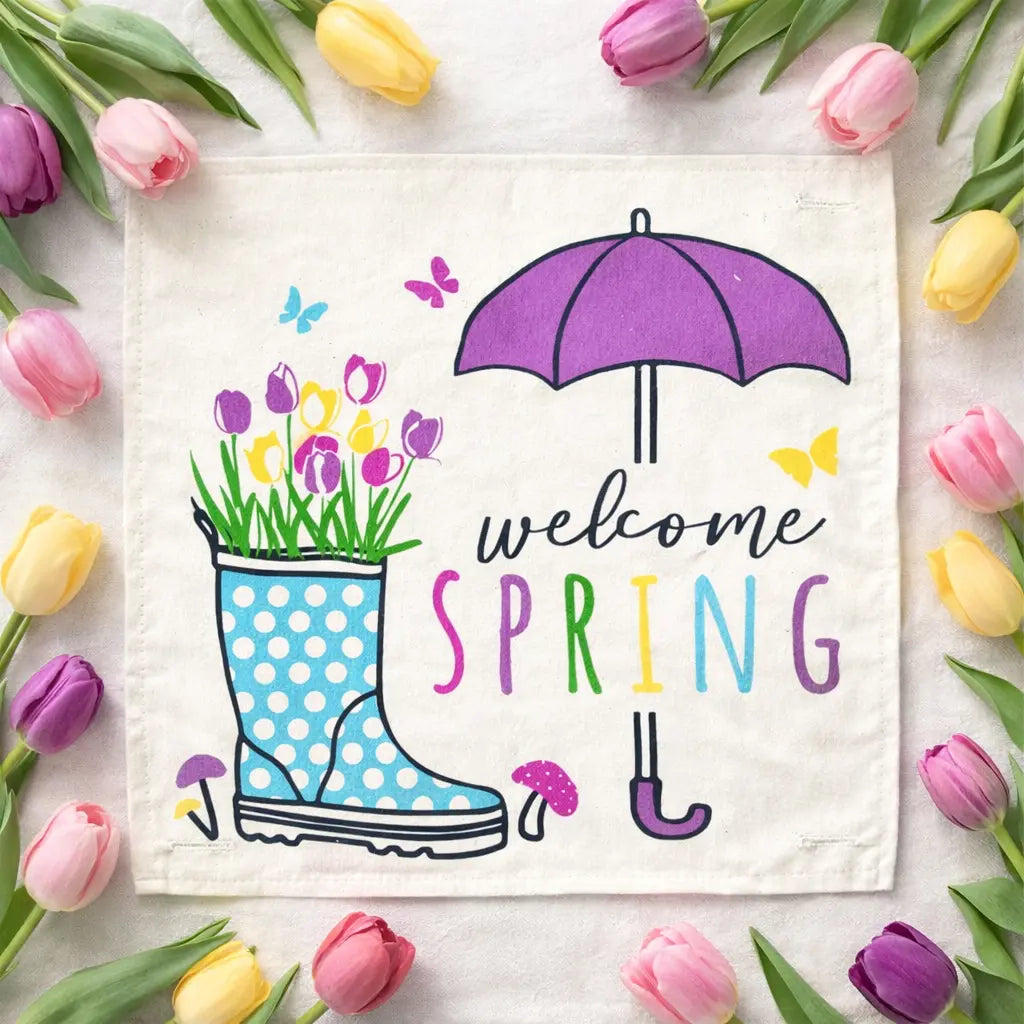 Decorative towel with 'Welcome Spring' text, rain boot, umbrella, and flowers on a white background with tulips around.