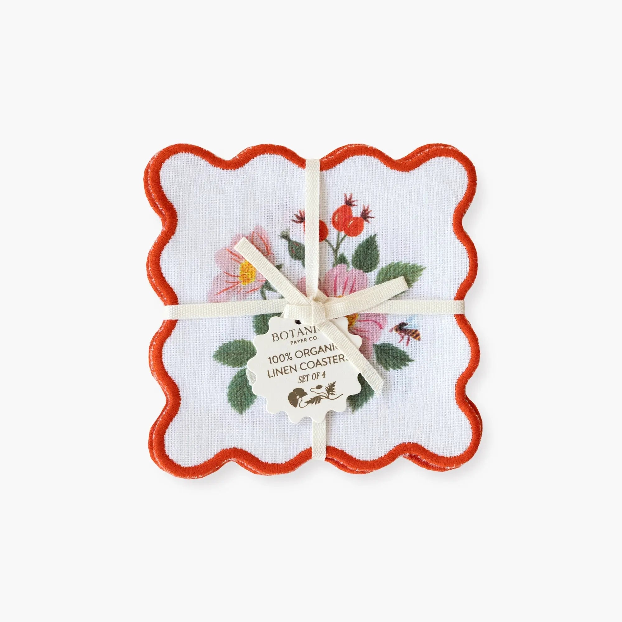Set of floral coasters with a red border in a decorative box on a white background