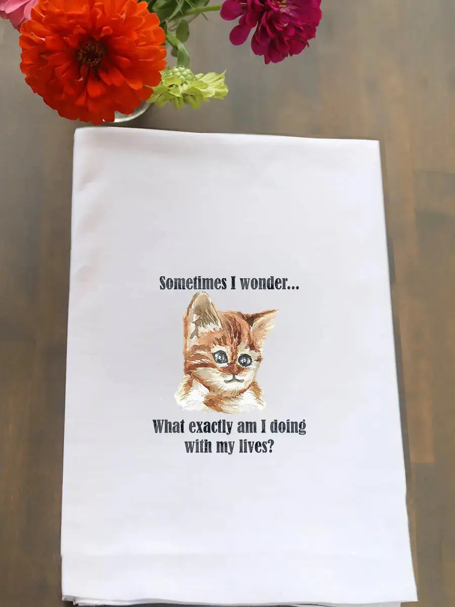 A white kitchen tea towel with a printed illustration of a kitten and the text 'Sometimes I wonder.