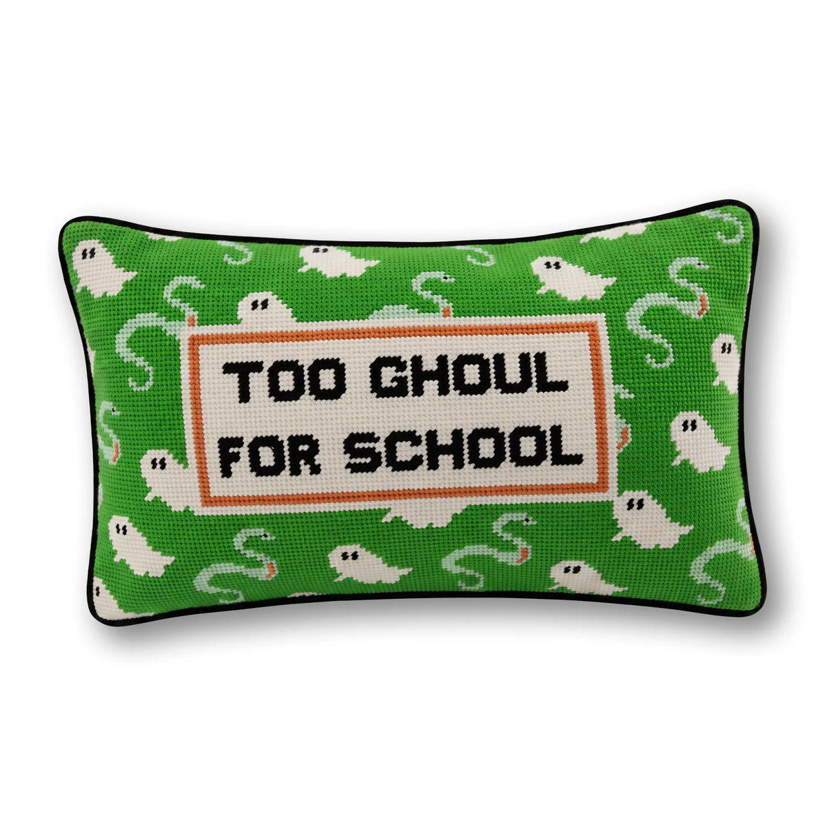 A rectangular decorative pillow with a green background patterned with white ghosts and black piped edges. The center features a cream-colored square patch with the text 'TOO GHOUL FOR SCHOOL' in black, framed by an orange border.