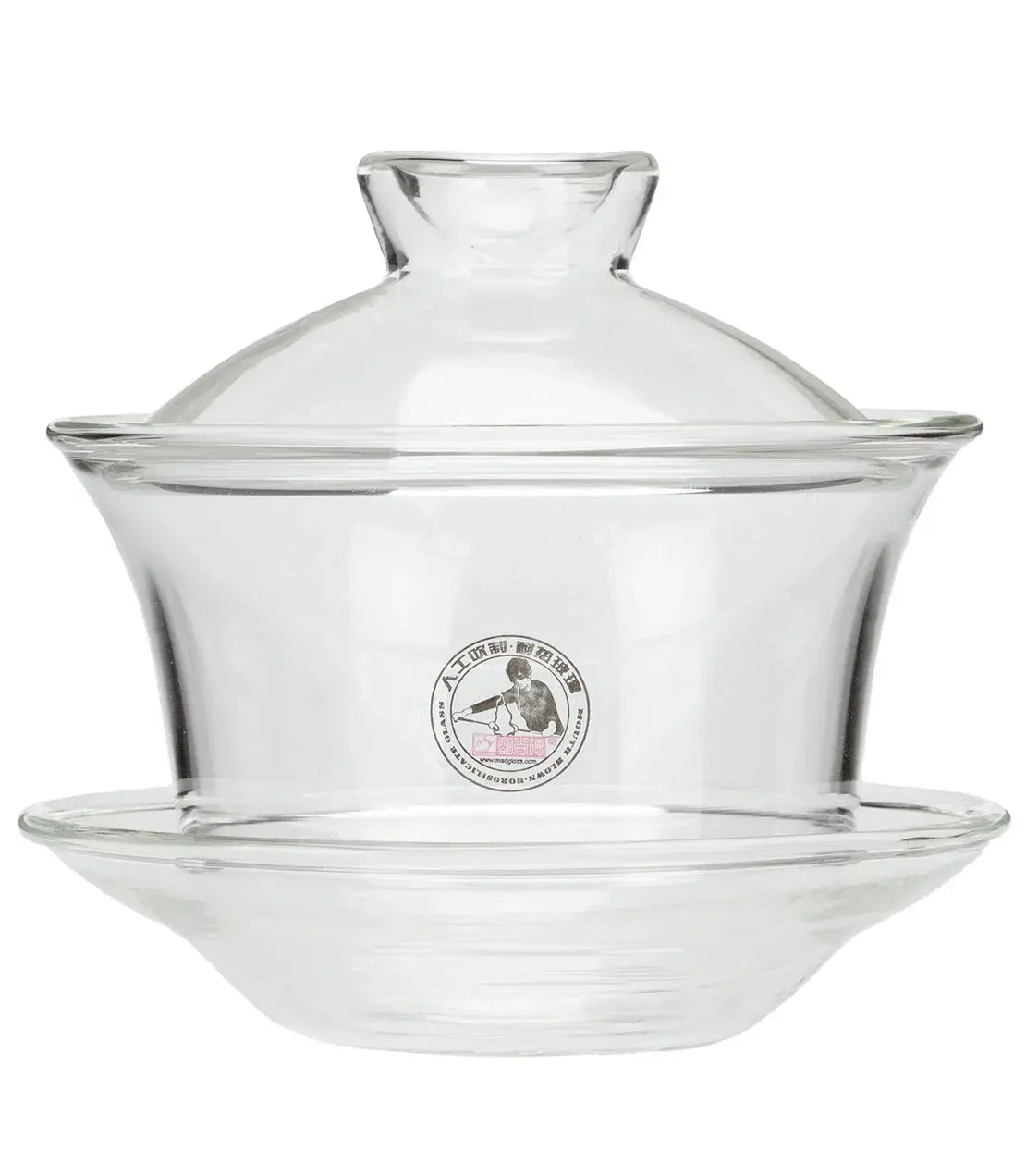 Clear glass teapot with lid and saucer, ideal for cozy farmhouse kitchen decor and tea lovers