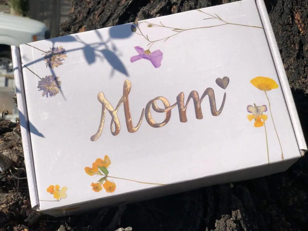 White gift box with 'Mom' in gold script and floral design, perfect for cozy home decor or thoughtful gifts