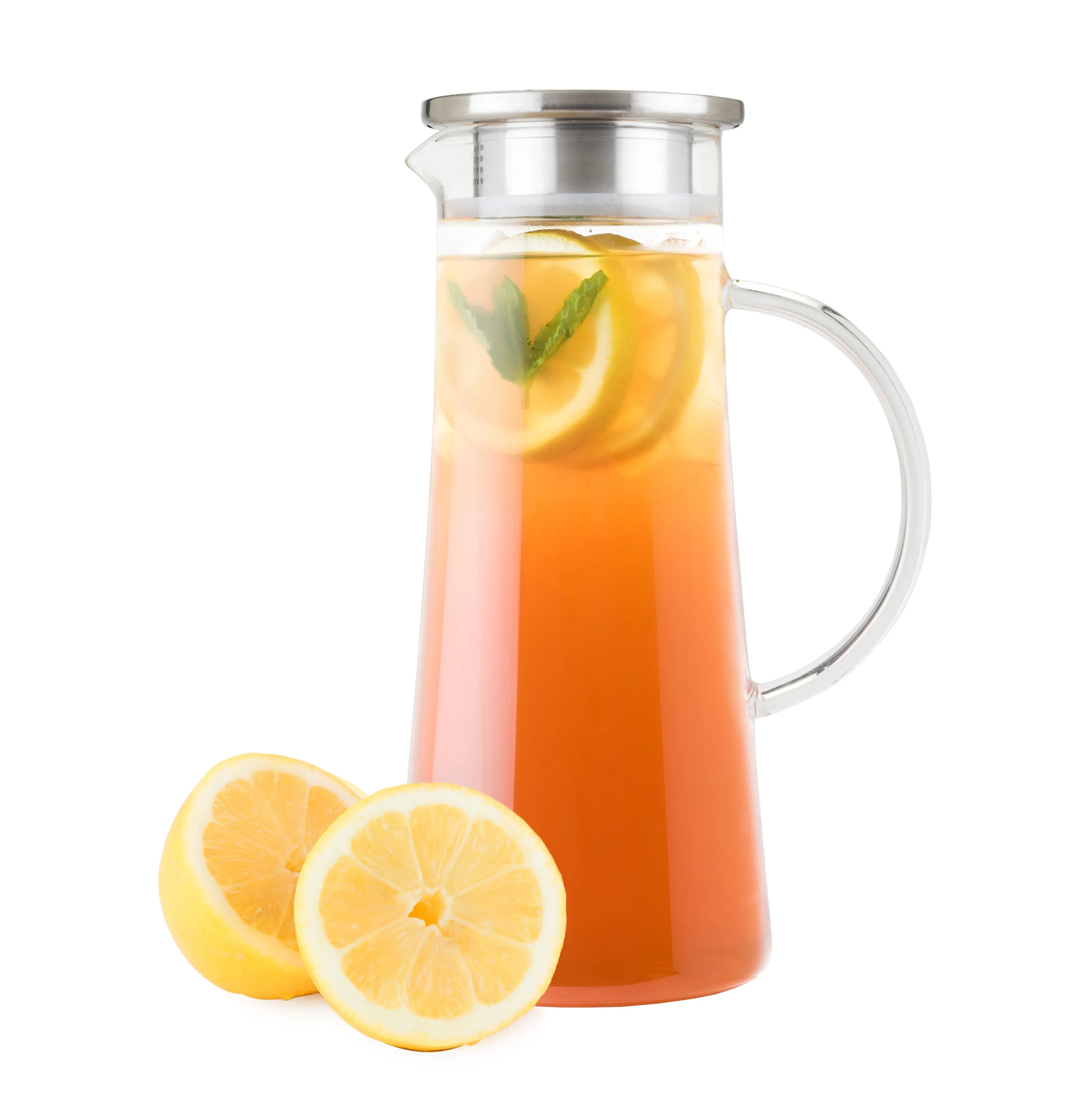 Glass pitcher filled with iced tea and lemon slices on a white background