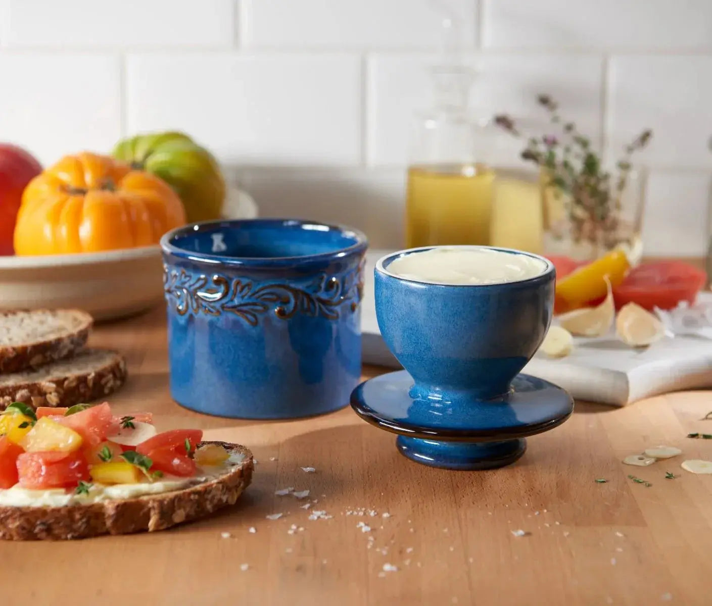 Blue ceramic butter dish with leaf design, farmhouse kitchen decor, served with fresh tomato toast