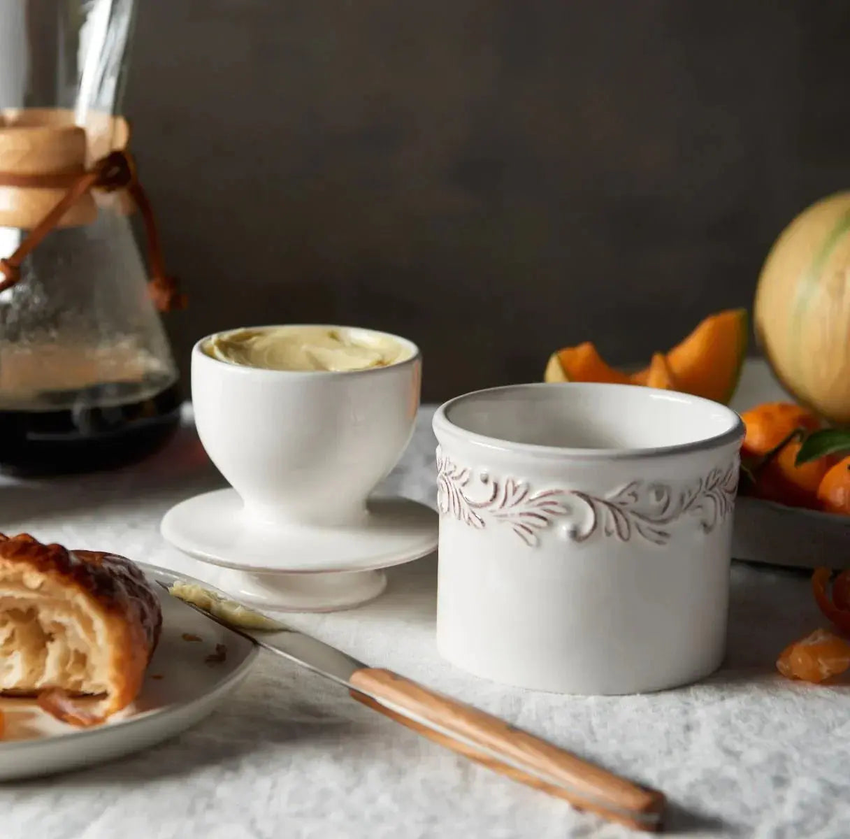White ceramic butter dish with floral embossing, perfect for farmhouse kitchen decor and cozy breakfasts