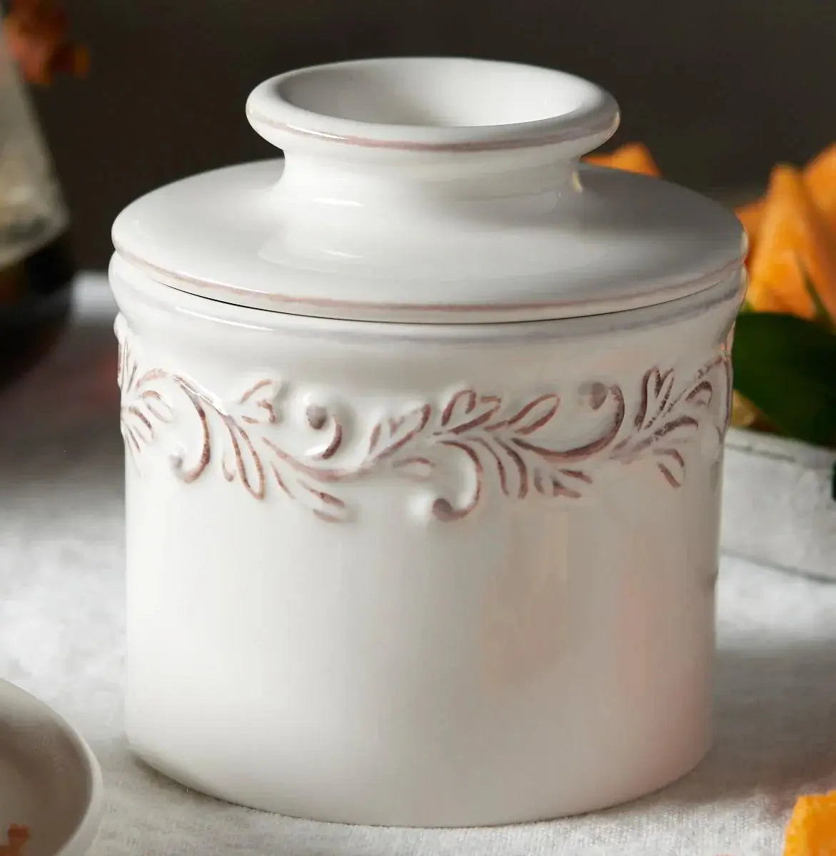 White ceramic canister with rustic leaf design, farmhouse kitchen decor