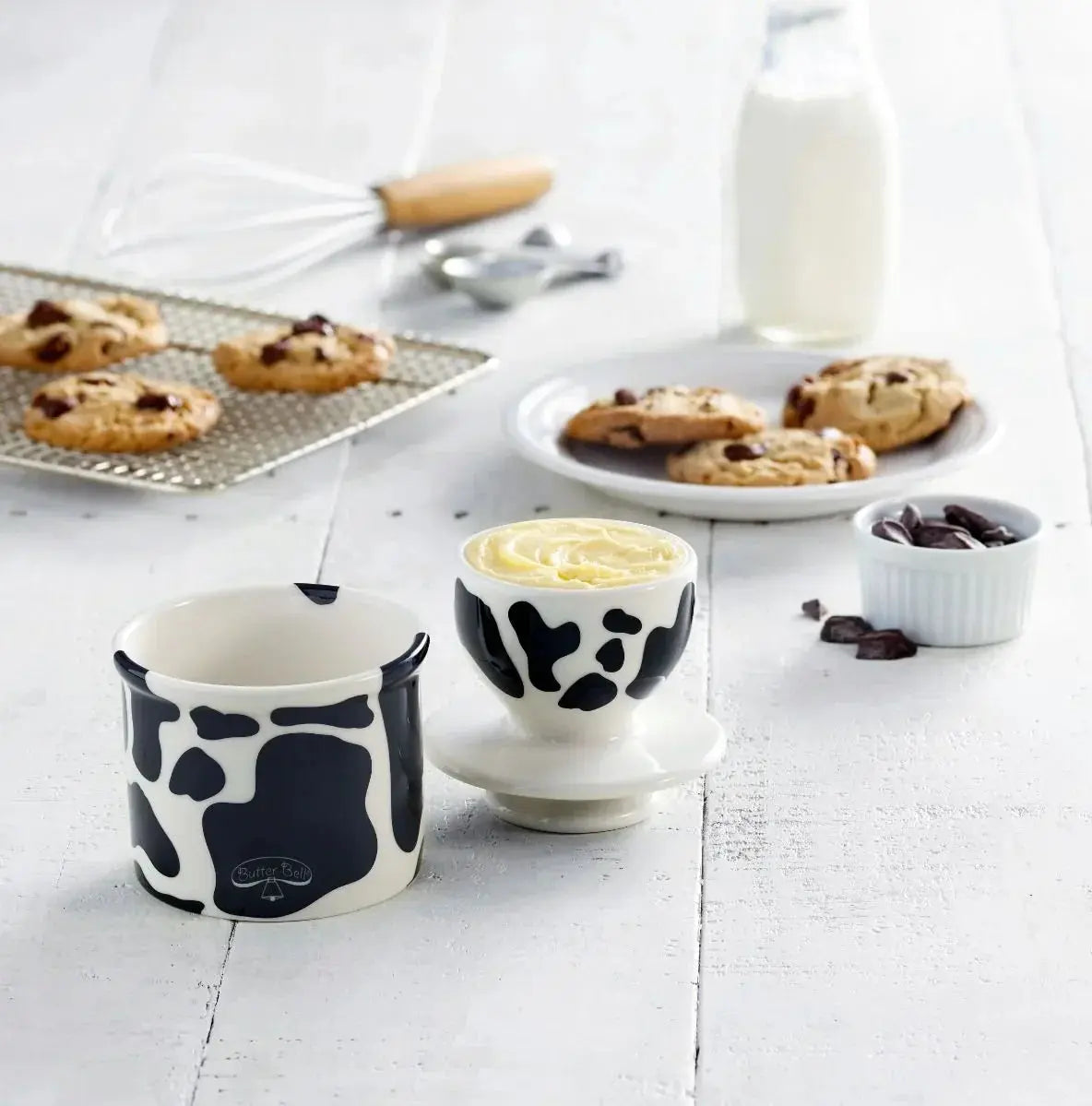 Cow print butter dish and ramekin with fresh cookies, cozy farmhouse kitchen decor
