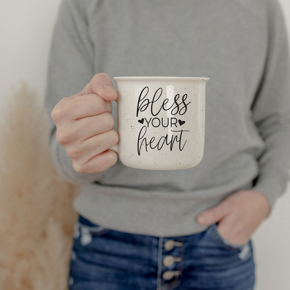 Person holding a mug with 'bless your heart' text