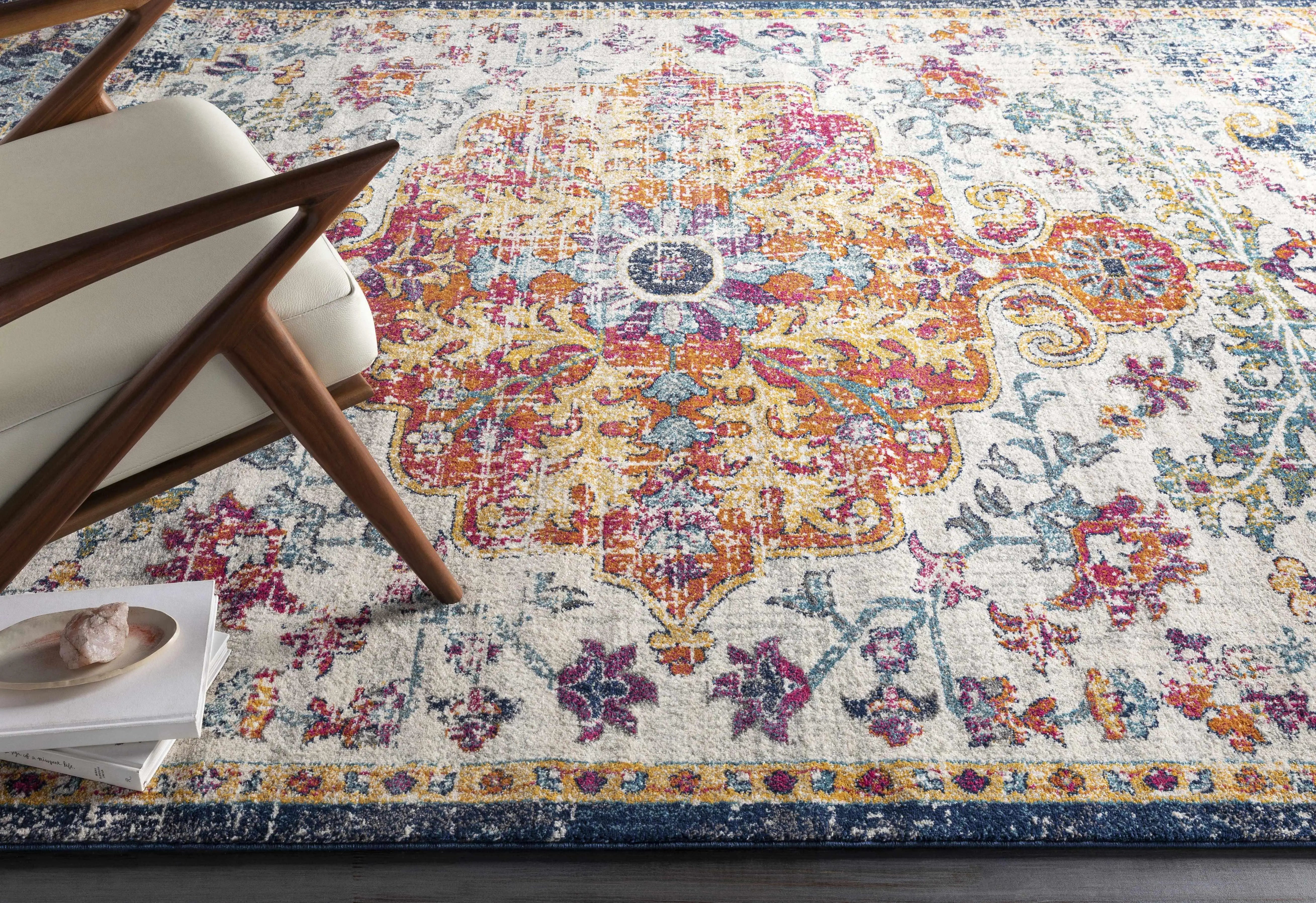 Colorful boho rug with floral pattern under modern chair, perfect for cozy farmhouse living room decor