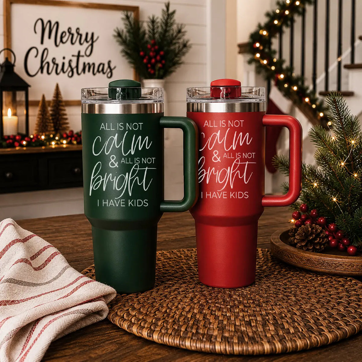 Two tumblers with humorous text on a decorative table with Christmas decorations.