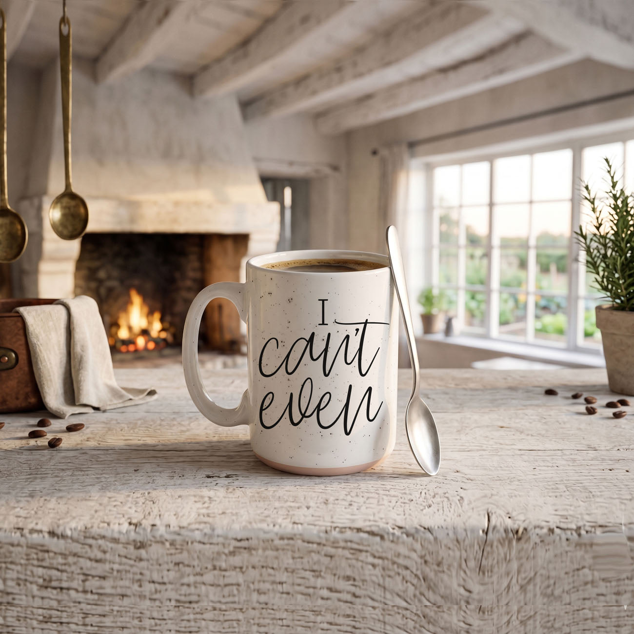 Mug with 'I can't even' text on a wooden table in a cozy room with a fireplace.