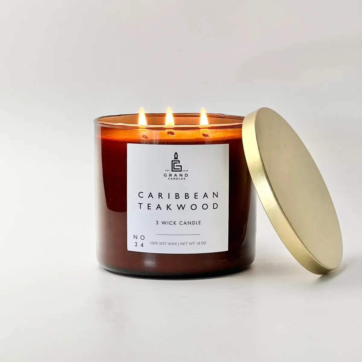 Caribbean Teakwood 3-wick soy candle in amber glass with gold lid, cozy home decor