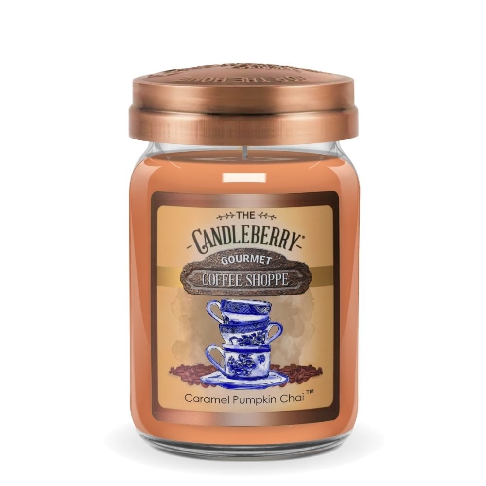 A single candle in a clear glass jar with a copper-toned metal lid, labeled 'The Candleberry Gourmet Coffee Shoppe' and 'Caramel Pumpkin Chai'. The candle wax is a warm orange-brown color, and the label features blue and white illustrations of stacked teacups with coffee beans on a beige background.