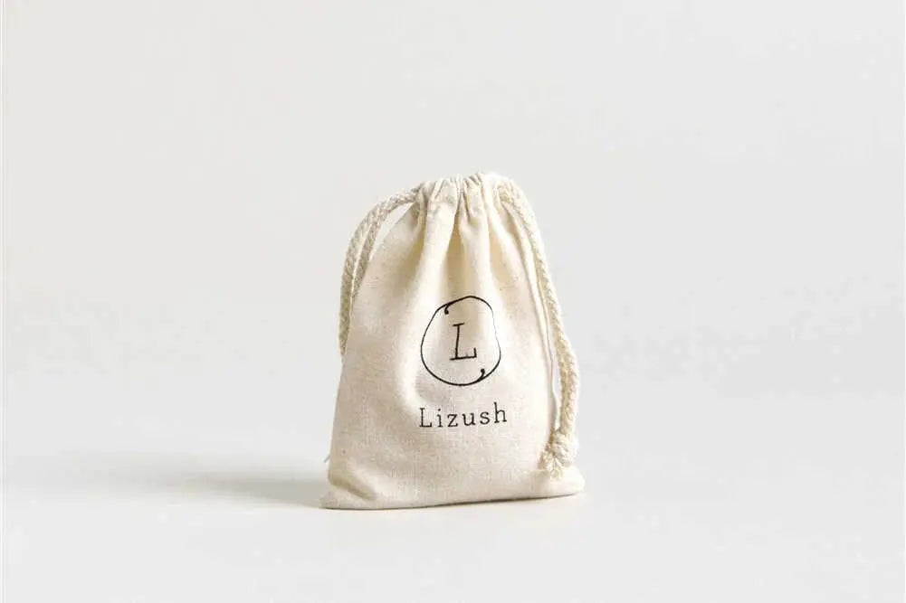 Cream drawstring gift bag with 'Lizush' monogram, perfect for cozy home decor and thoughtful gifts