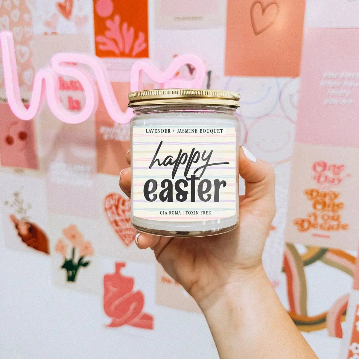 Hand holding a 'Happy Easter' candle jar with a colorful background