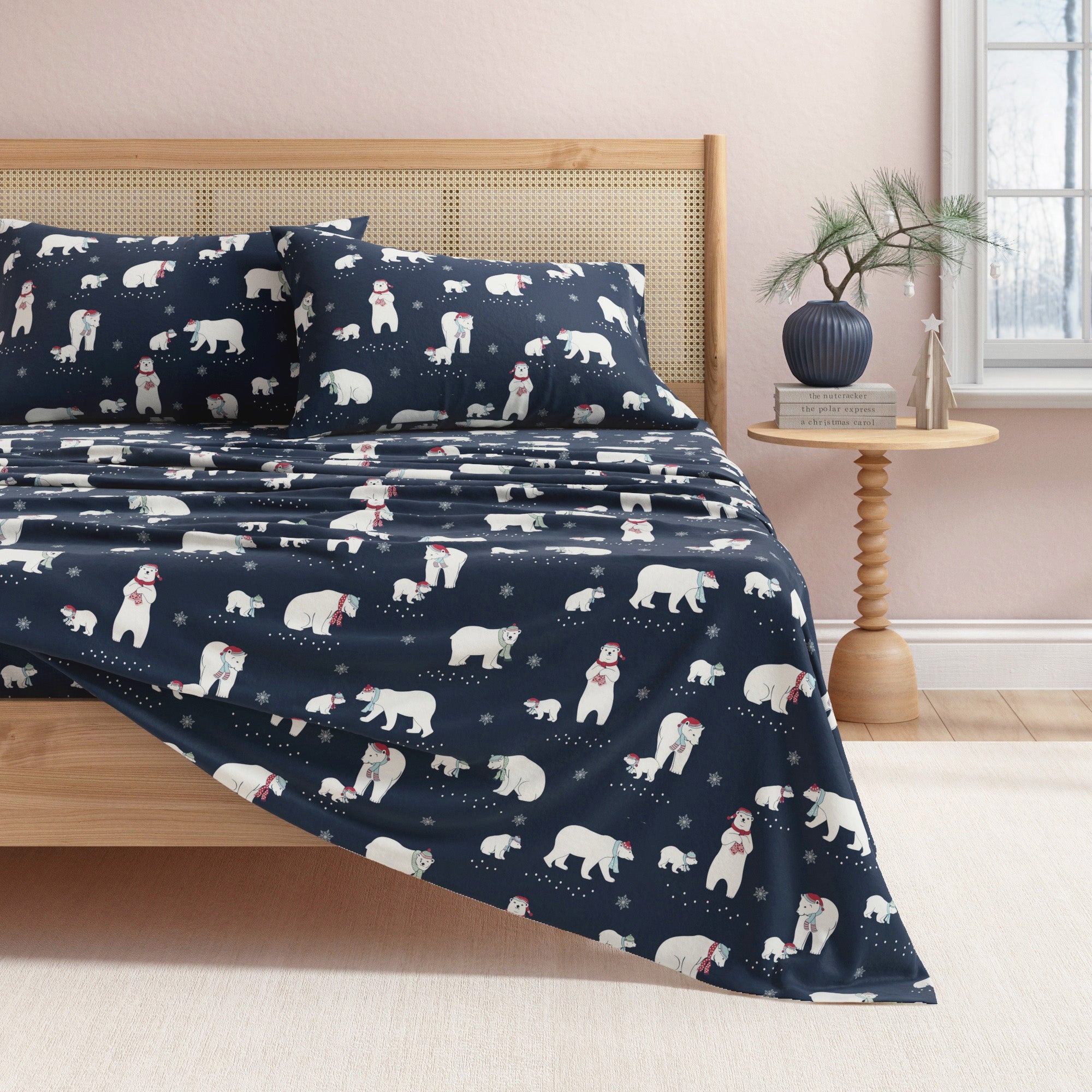 Navy blue bedding set with polar bear pattern on a bed in a bedroom.