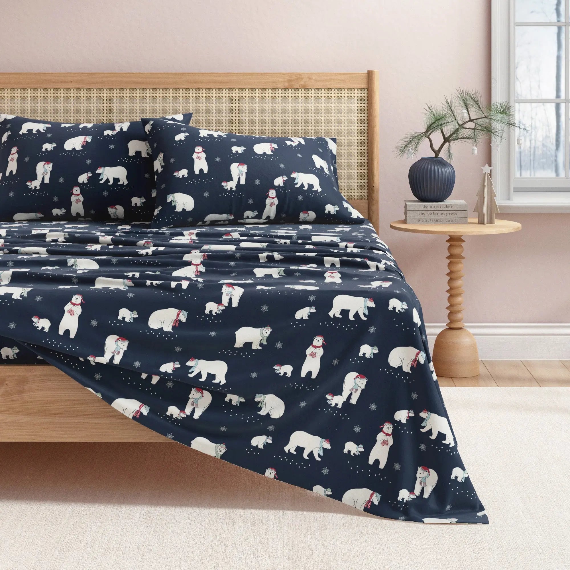Navy blue bedding set with polar bear pattern on a bed in a bedroom.