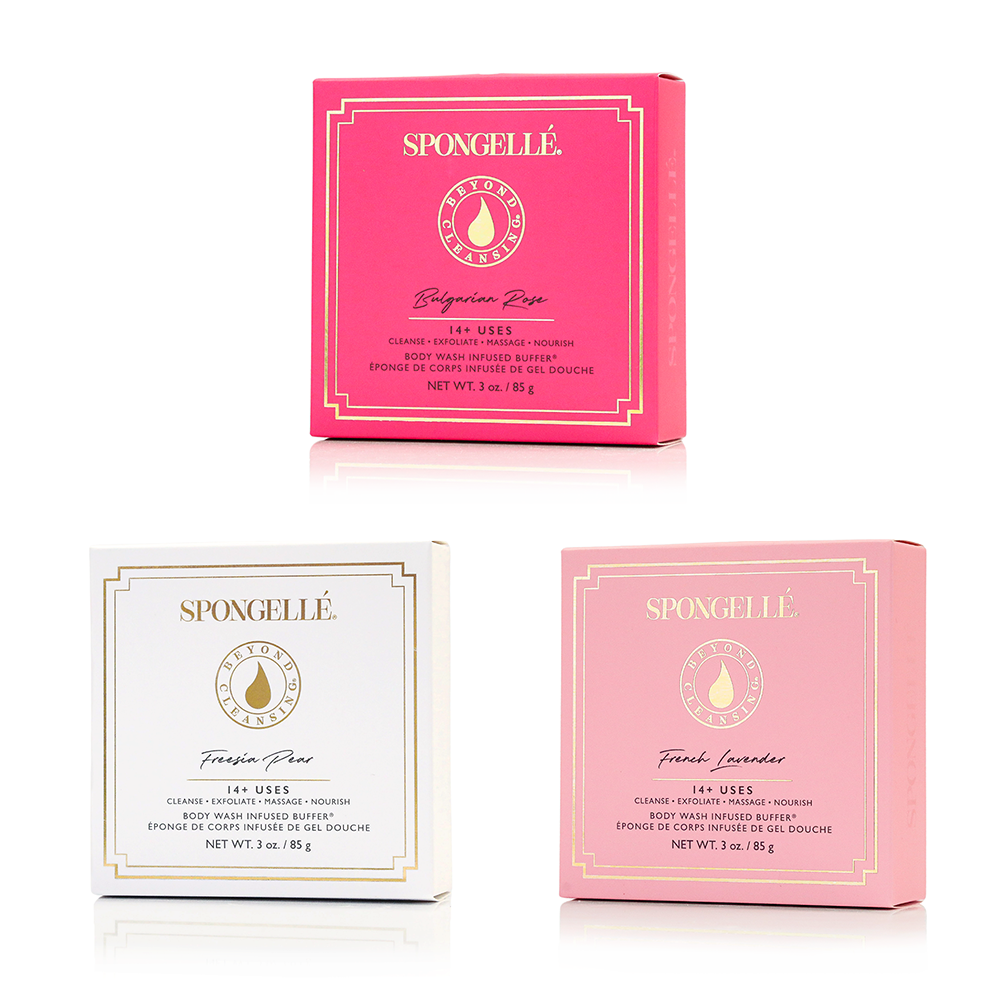 Three Spongellé product boxes in pink, white, and light pink on a white background