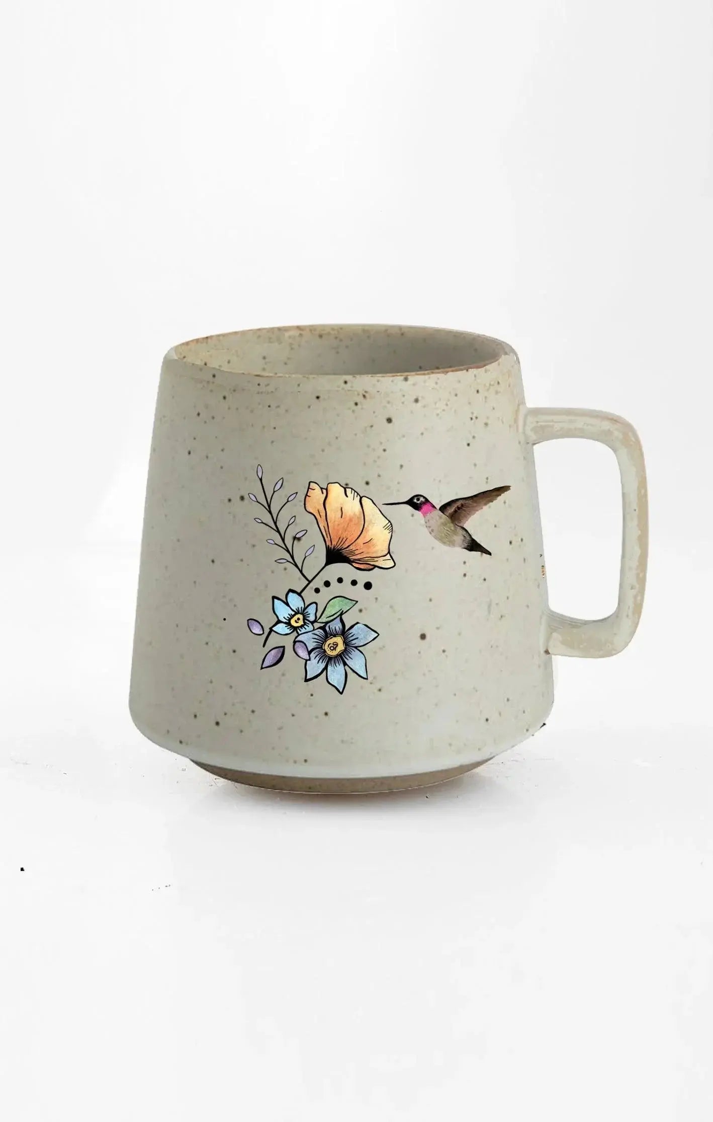 Speckled ceramic mug with hummingbird and floral design, cozy farmhouse decor