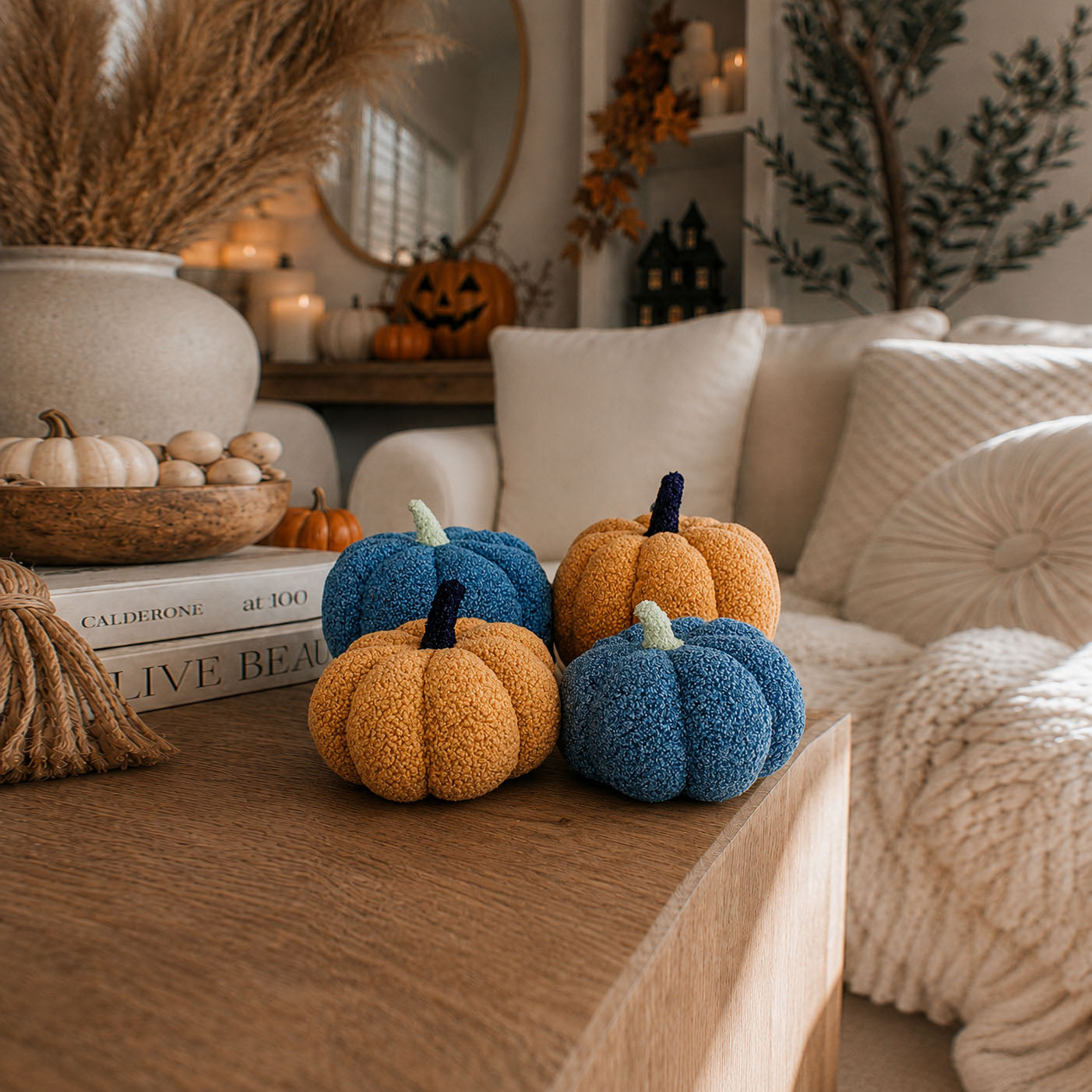 Decorative pumpkins on a coffee table with a cozy living room background
