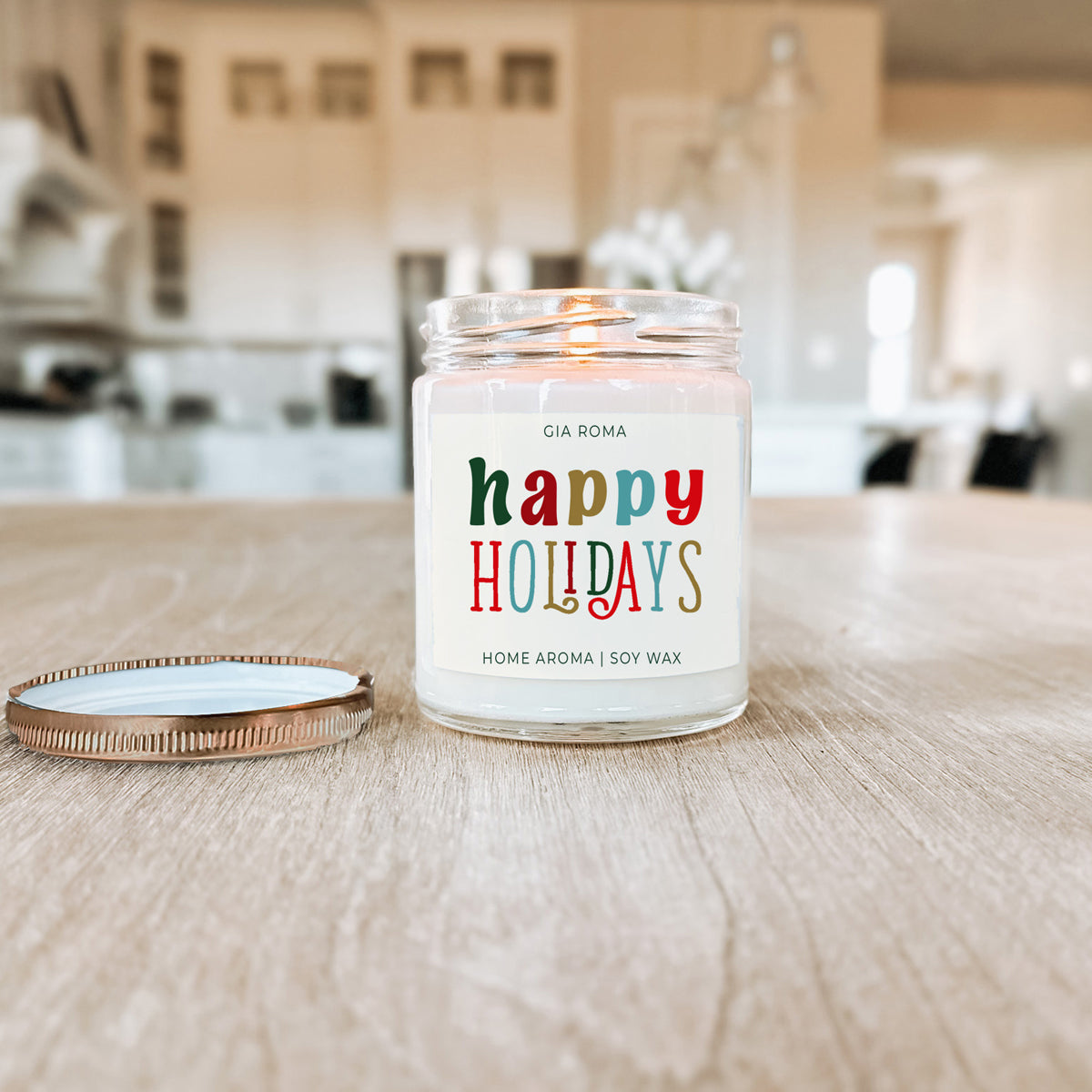 Candle with 'happy holidays' label on a wooden surface