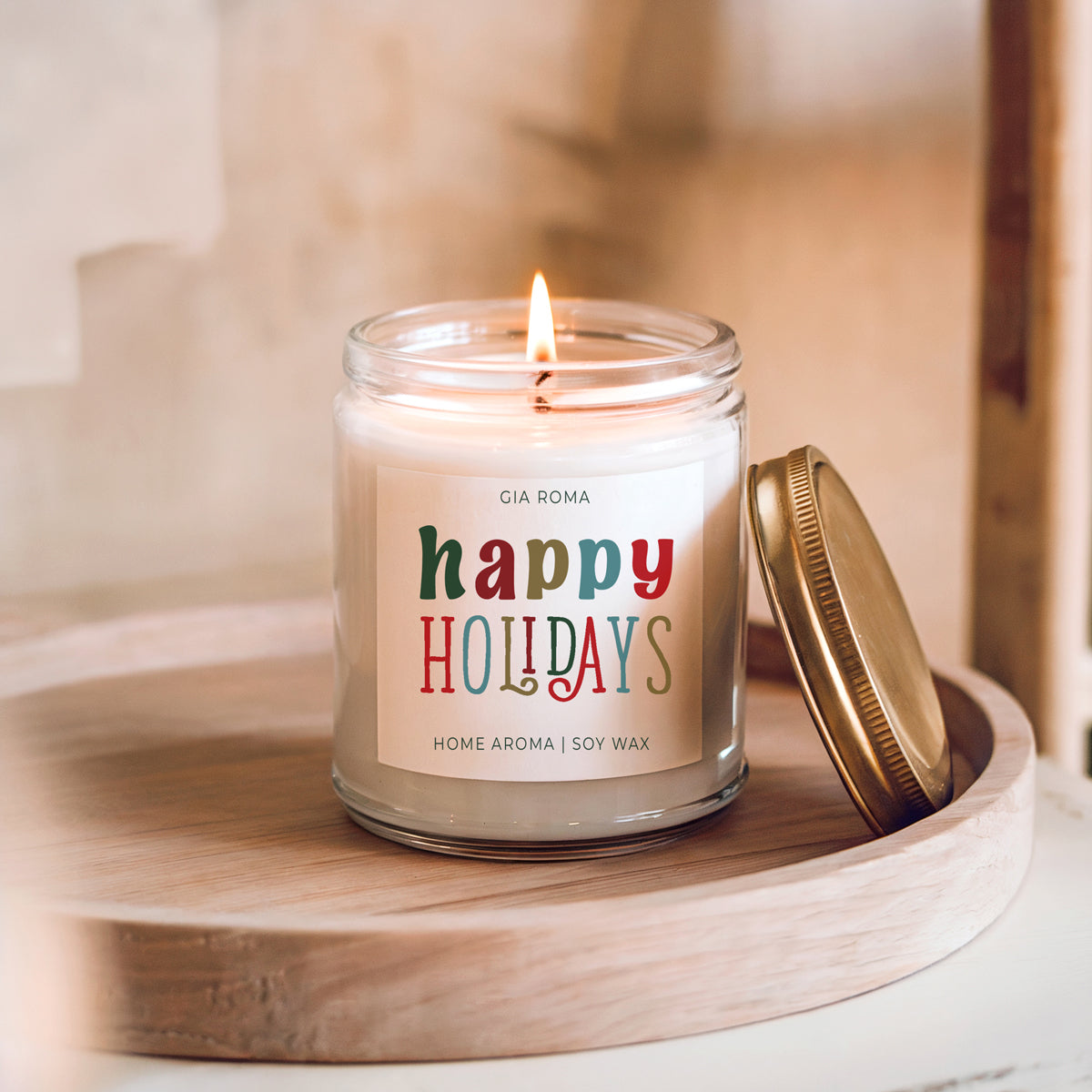 Candle in a jar with 'happy holidays' label on a wooden surface