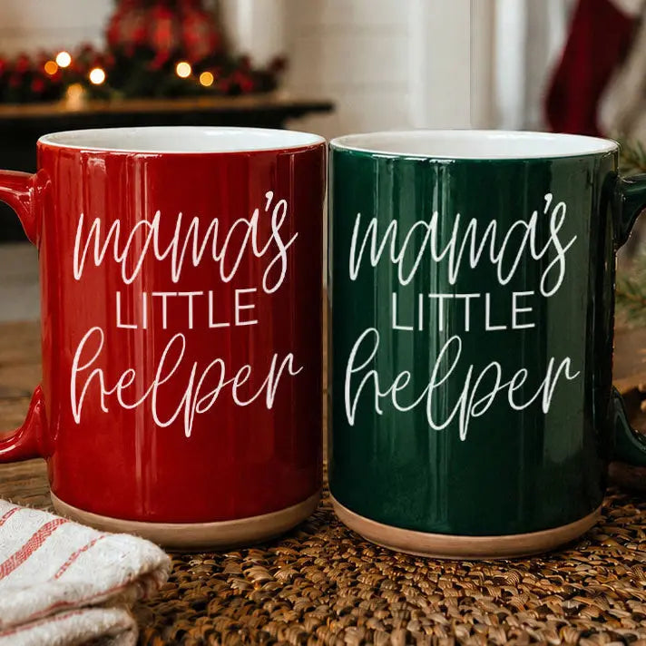 Two mugs with 'mama's little helper' text on a wooden surface.
