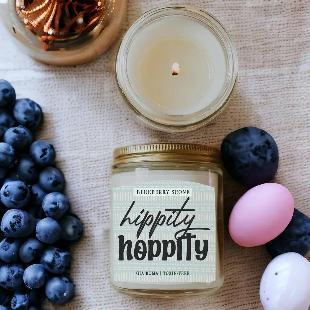 Hippity Hoppity candle jar with blueberries and Easter eggs on a textured surface