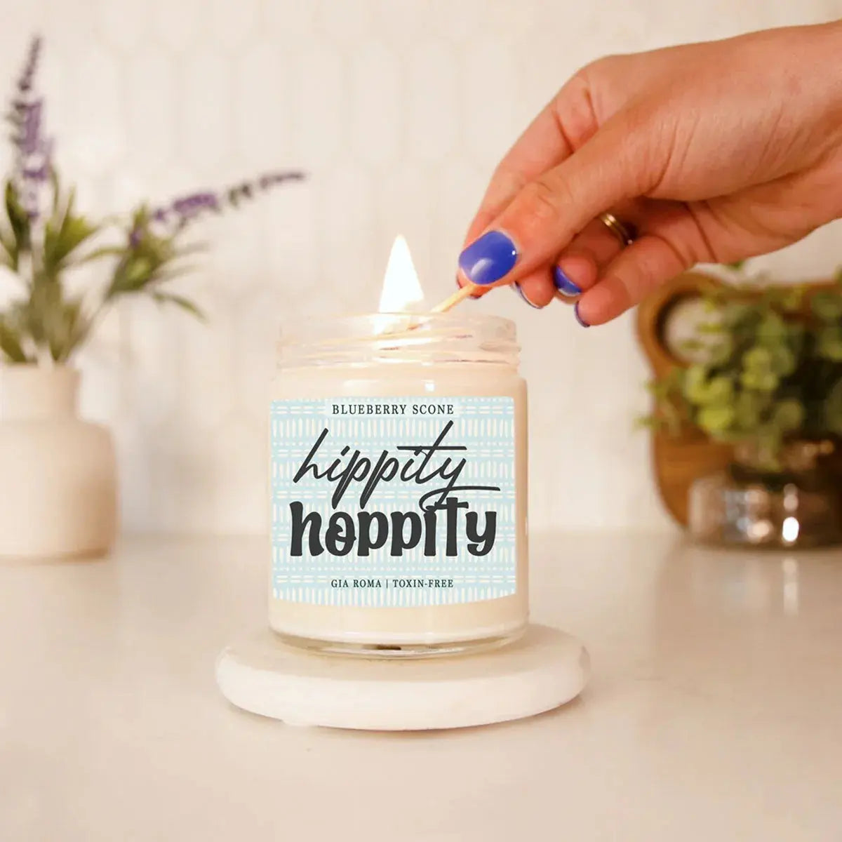 Candle being lit with a 'hippity hippity' label on a neutral background