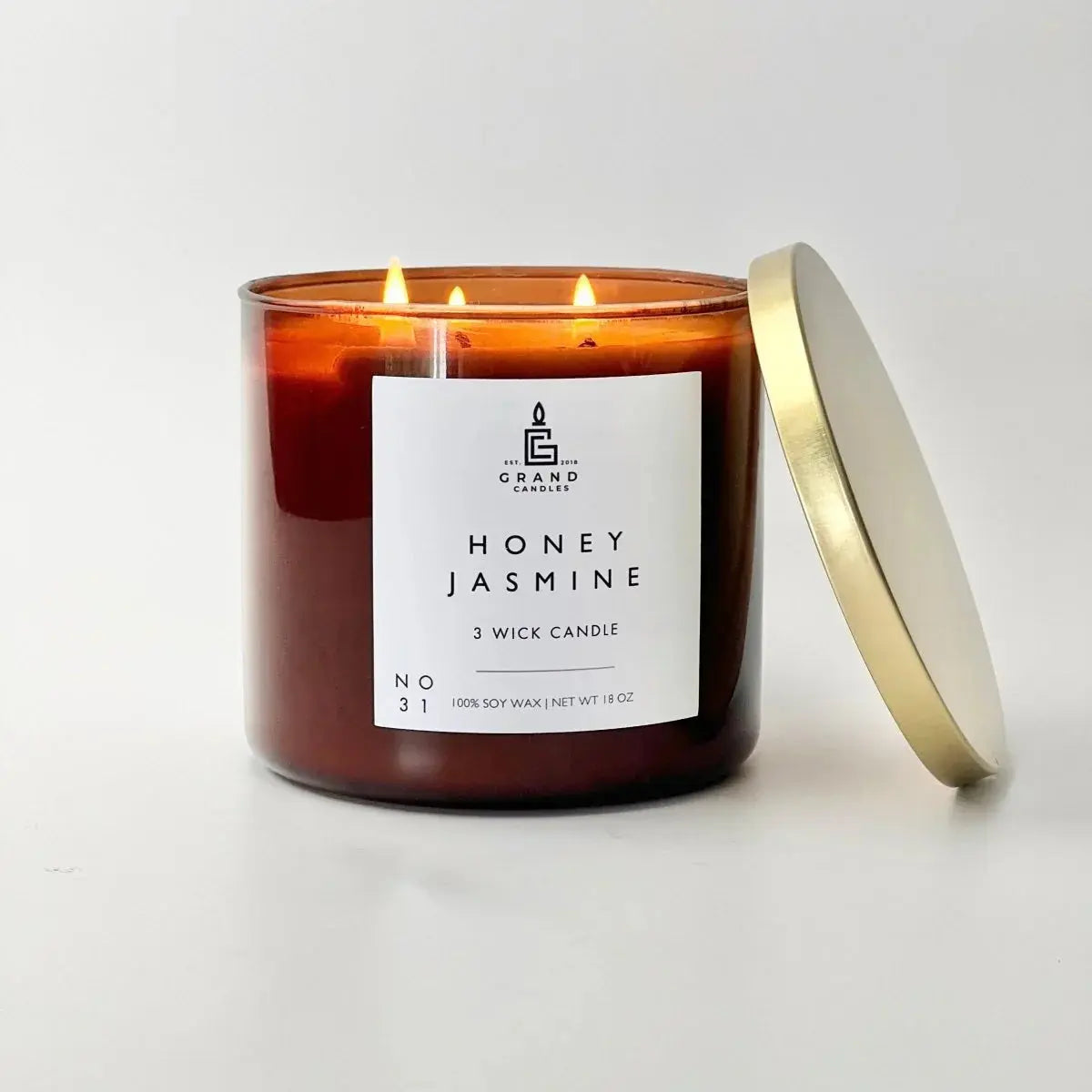 Honey Jasmine 3-wick soy candle in amber jar with gold lid, cozy home decor