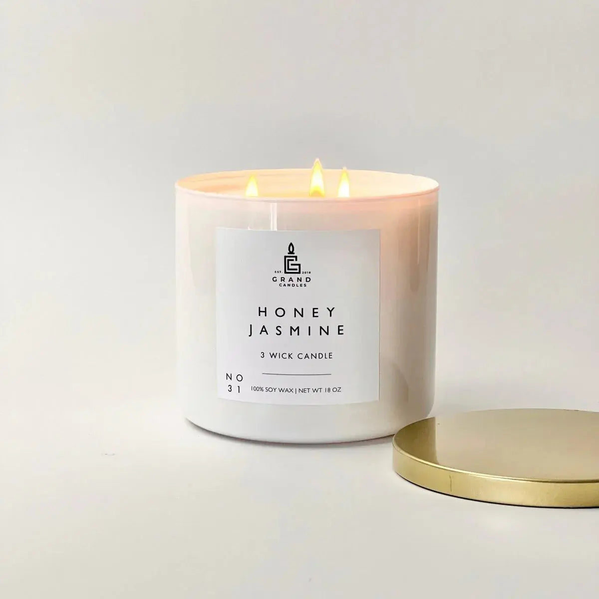Honey Jasmine 3-wick soy candle in white jar with gold lid, cozy home decor