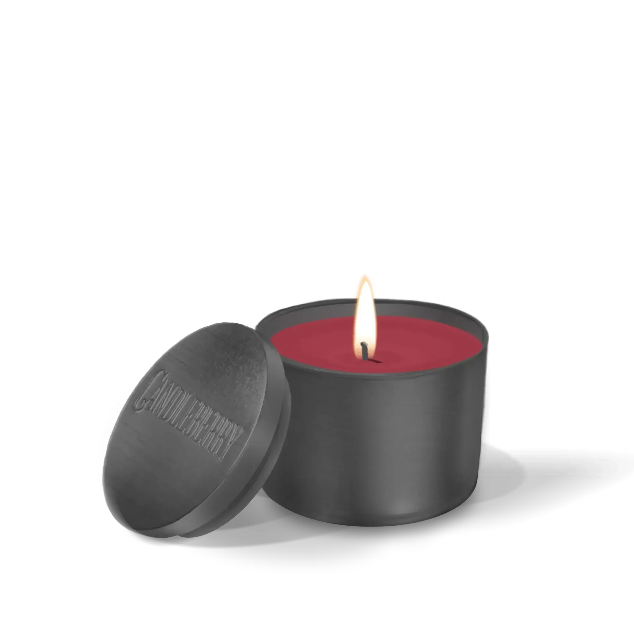 Lit red candle in matte black jar with lid, cozy home decor essential