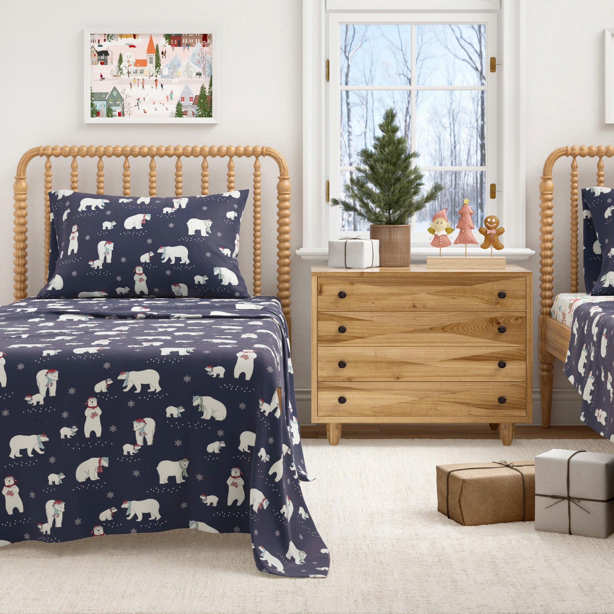 Children's bedroom with navy blue bedding featuring bears and stars, wooden furniture, and a small Christmas tree.