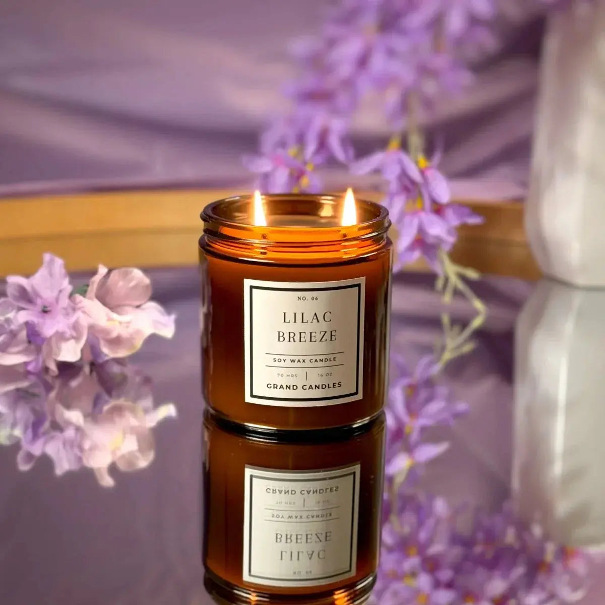 Lilac Breeze soy wax candle in amber jar, lit with purple flowers, cozy farmhouse home decor