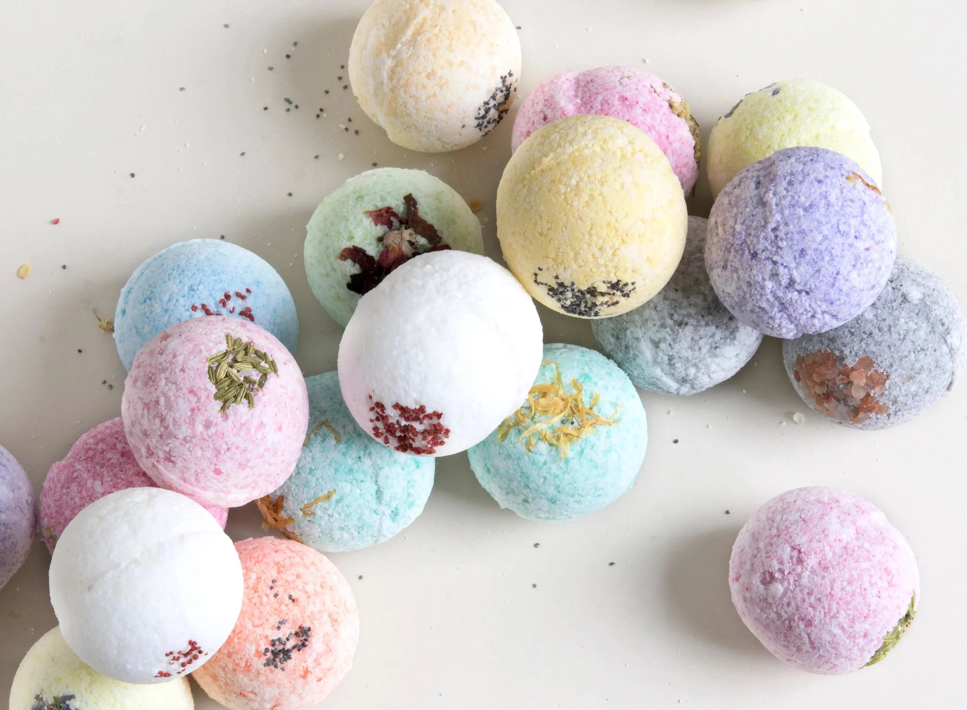 Colorful bath bombs with dried flowers and herbs, perfect for cozy farmhouse bath essentials and thoughtful gifts.