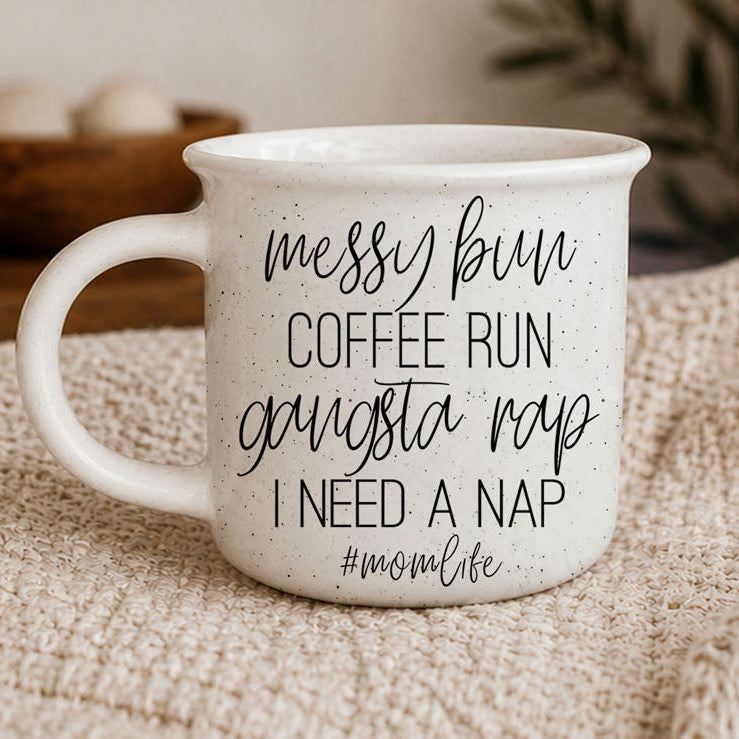 White ceramic mug with text on a textured surface