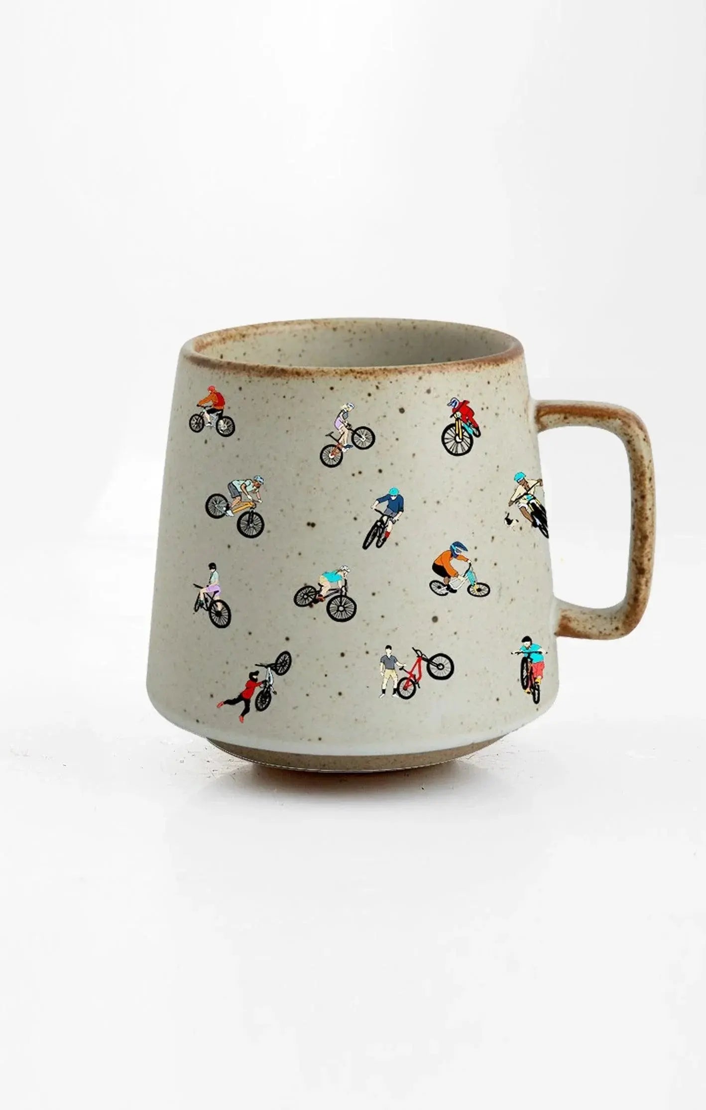 Speckled ceramic mug with colorful cyclist illustrations, cozy farmhouse decor