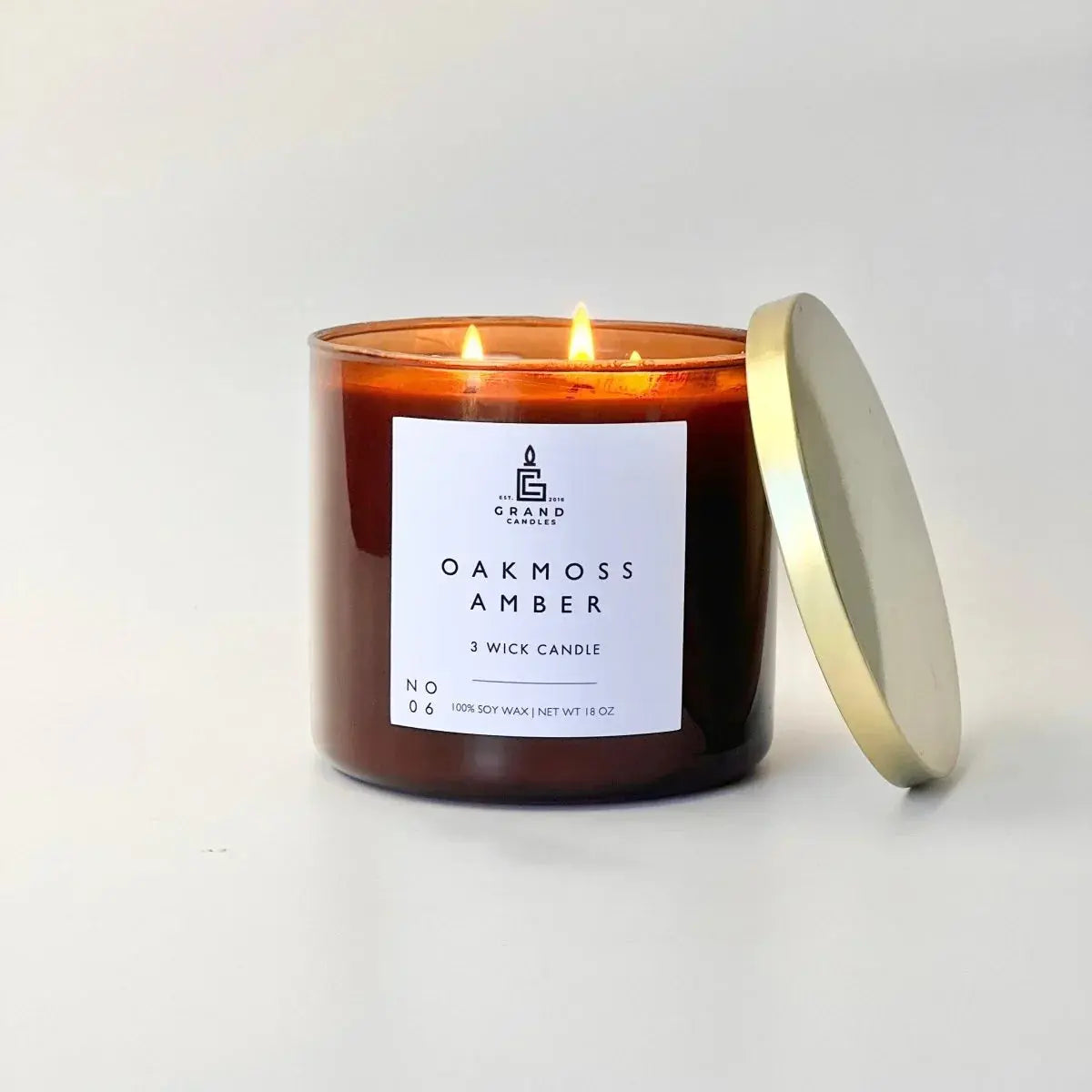 Oakmoss Amber 3-wick soy candle in amber glass with gold lid, cozy home decor