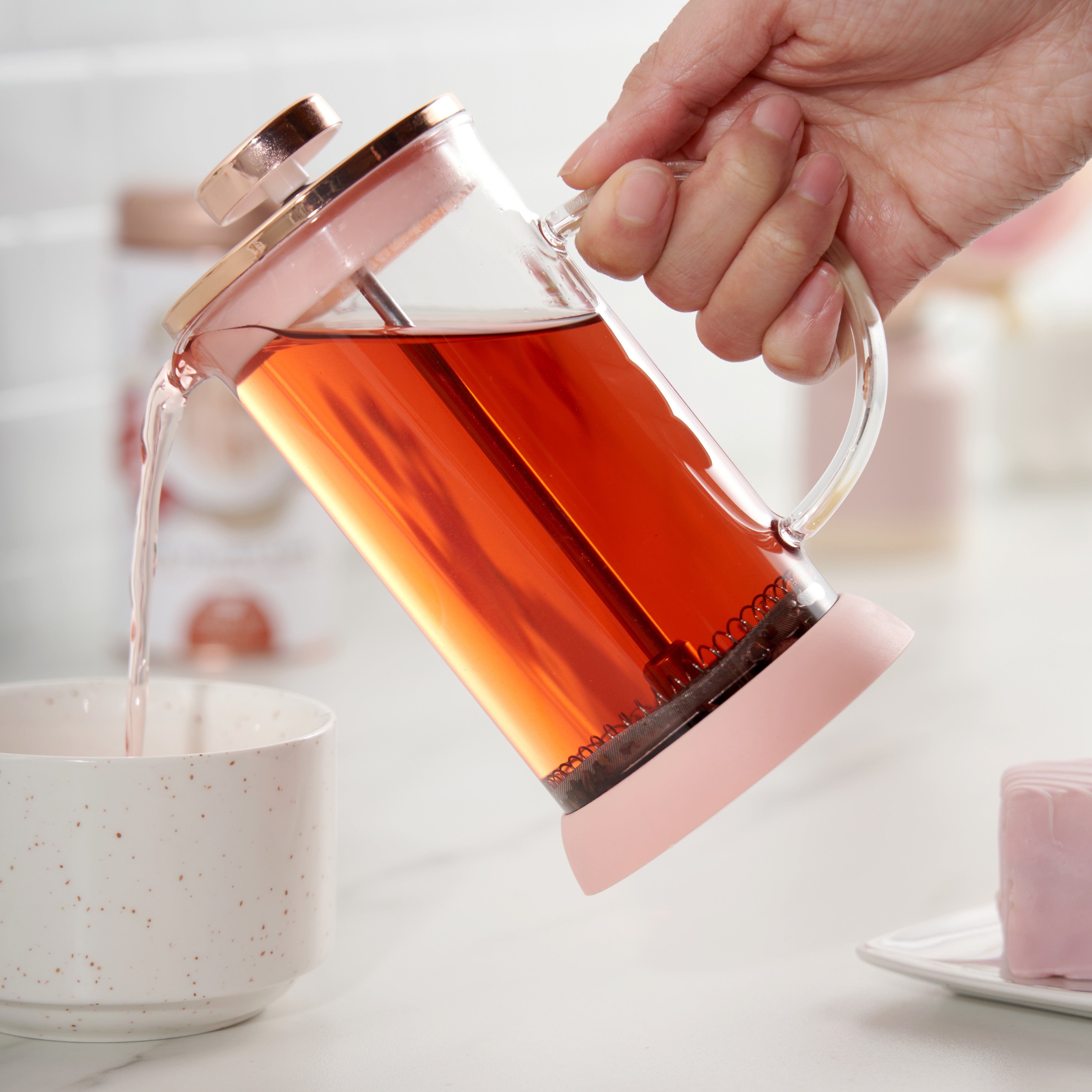 someone pouring coffee from the Rose gold French press coffee maker
