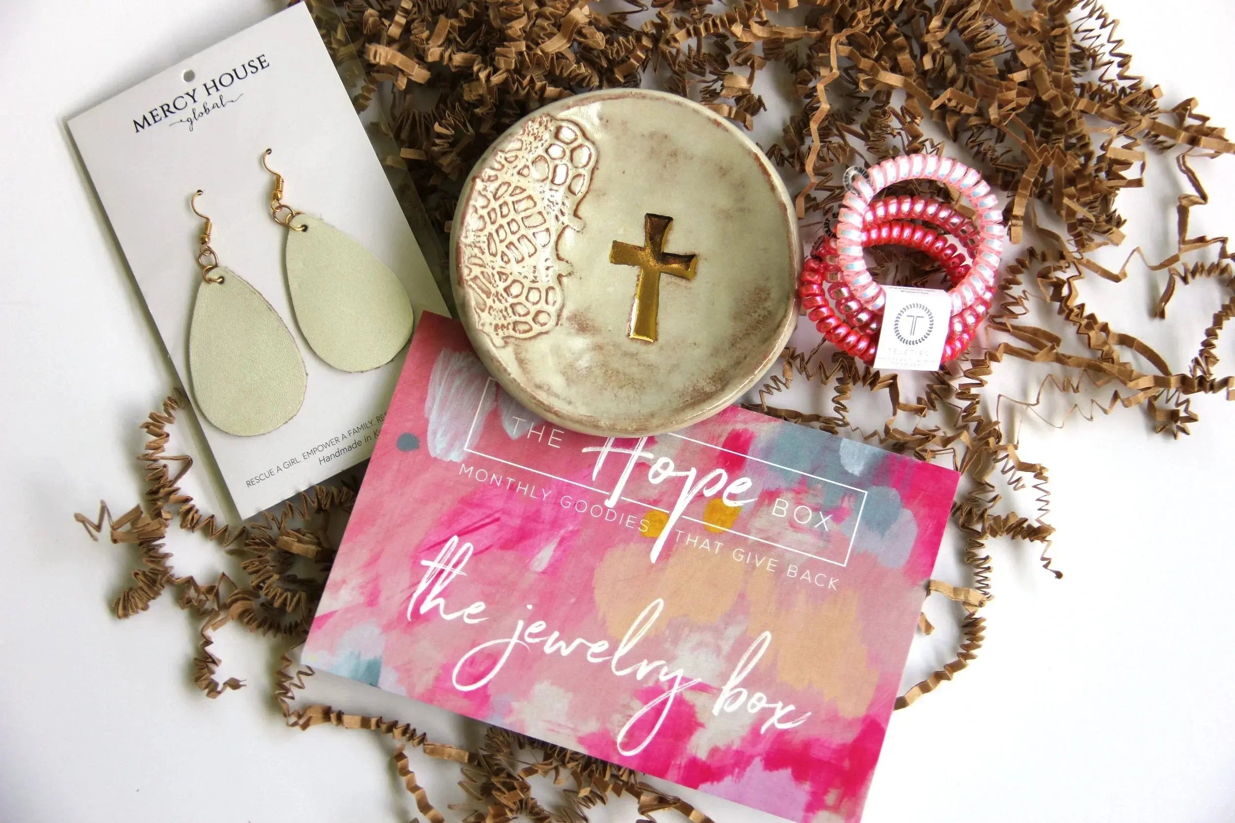 Hope Box jewelry set with cross dish, leather earrings, and hair ties in cozy gift packaging