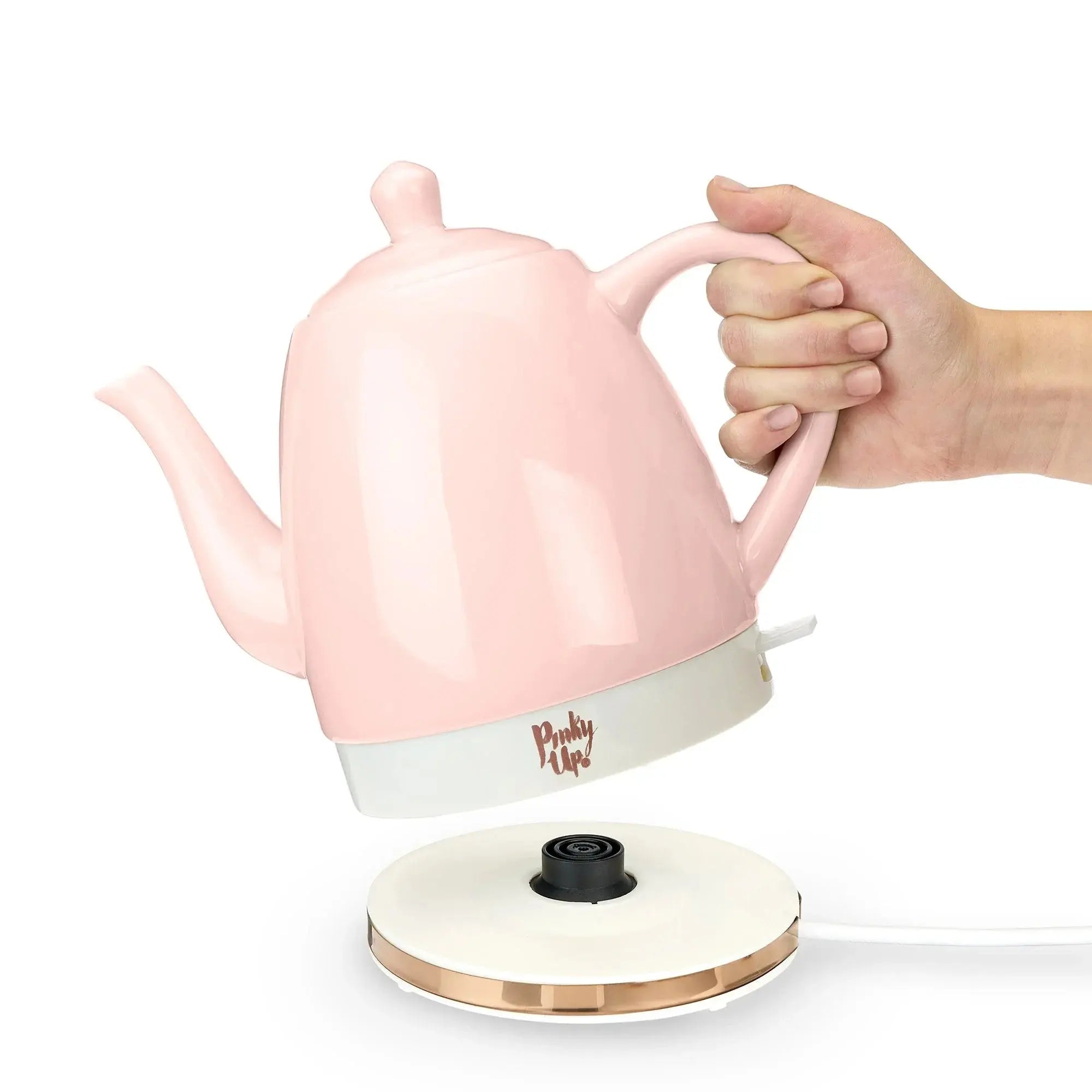 Pink electric kettle on a kitchen counter, showing how to set the tea pot on electric pad