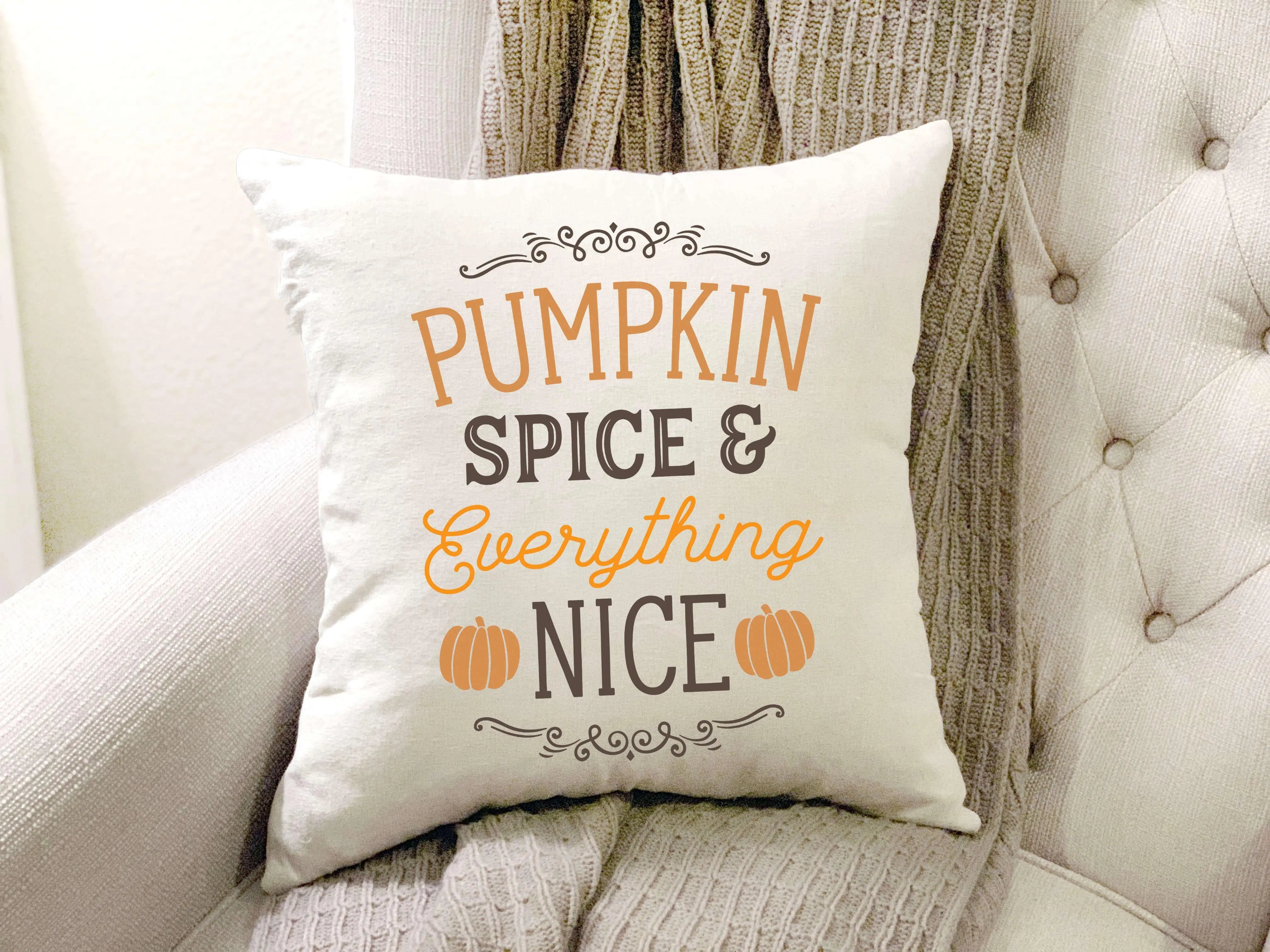 Pumpkin spice & everything nice fall pillow on cozy tufted chair with knit blanket, farmhouse decor